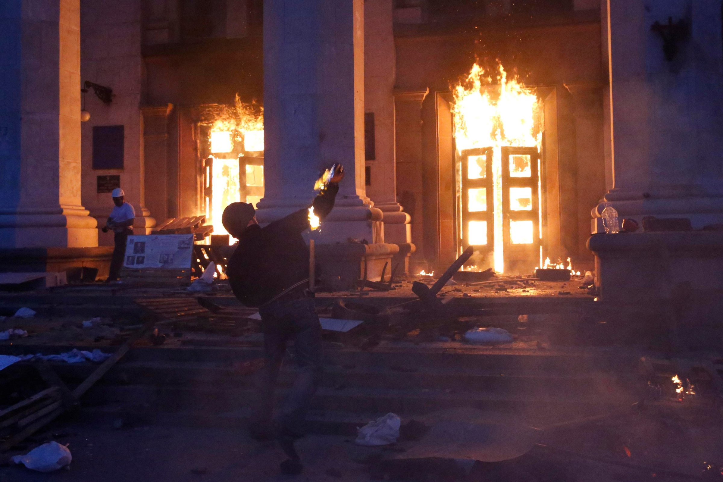 A protester throws a petrol bomb at the trade union building in Odessa