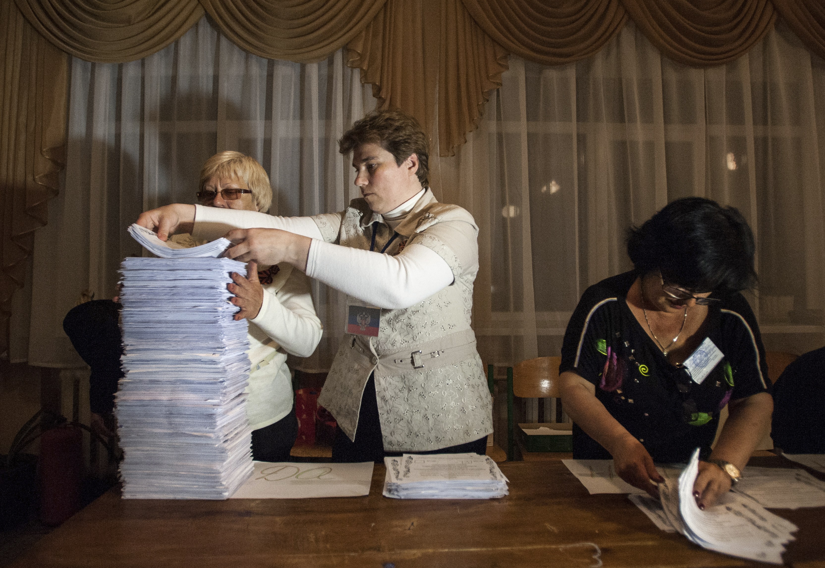 Members of an election committee empty a ballot box after voting closes at a polling station in Donetsk, Ukraine, Sunday, May 11, 2014. (Evgeniy Maloletka—AP)