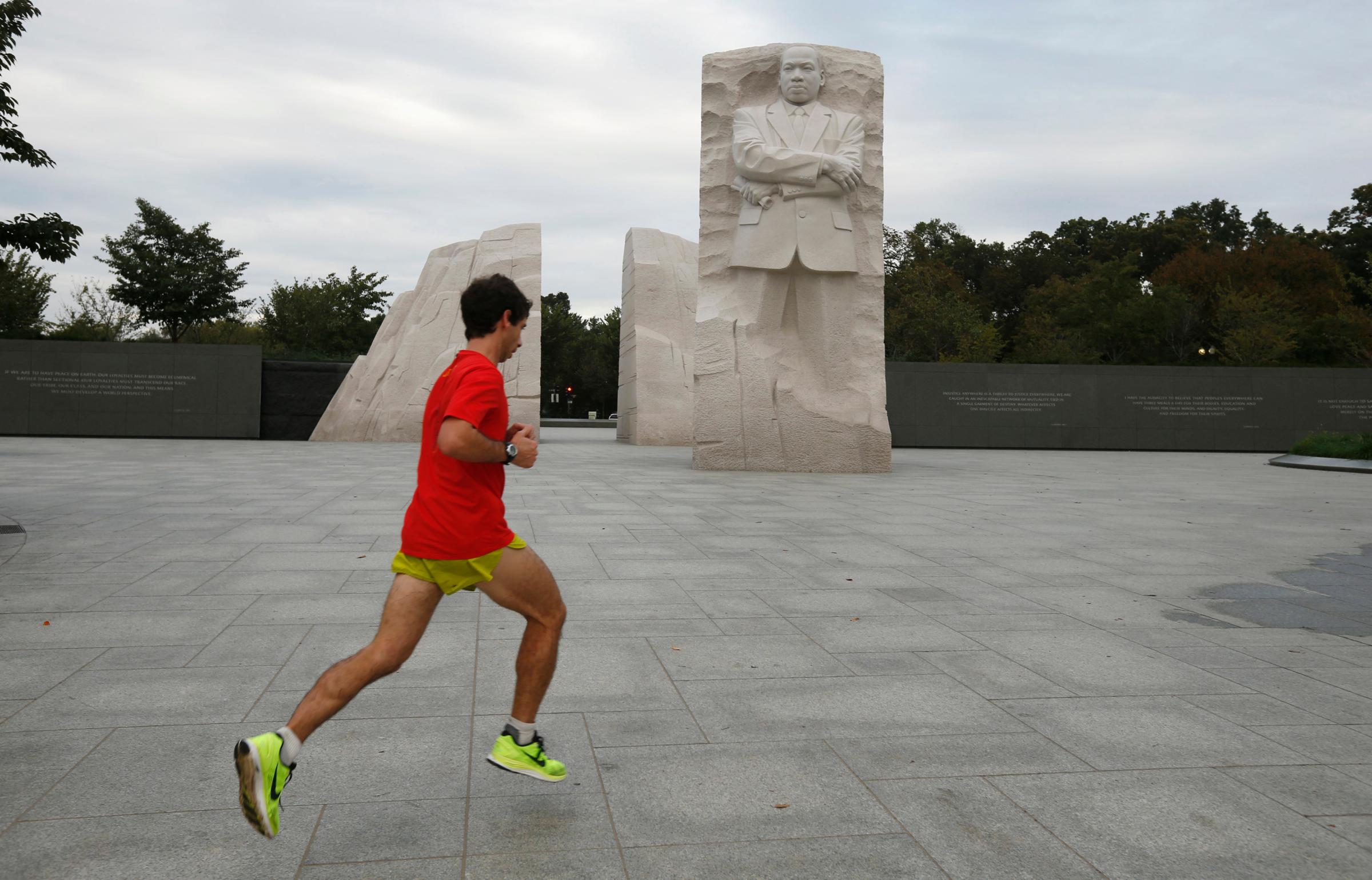 A jogger passes the Martin Luther King Jr. Memorial after it was re-opened to the public in Washington