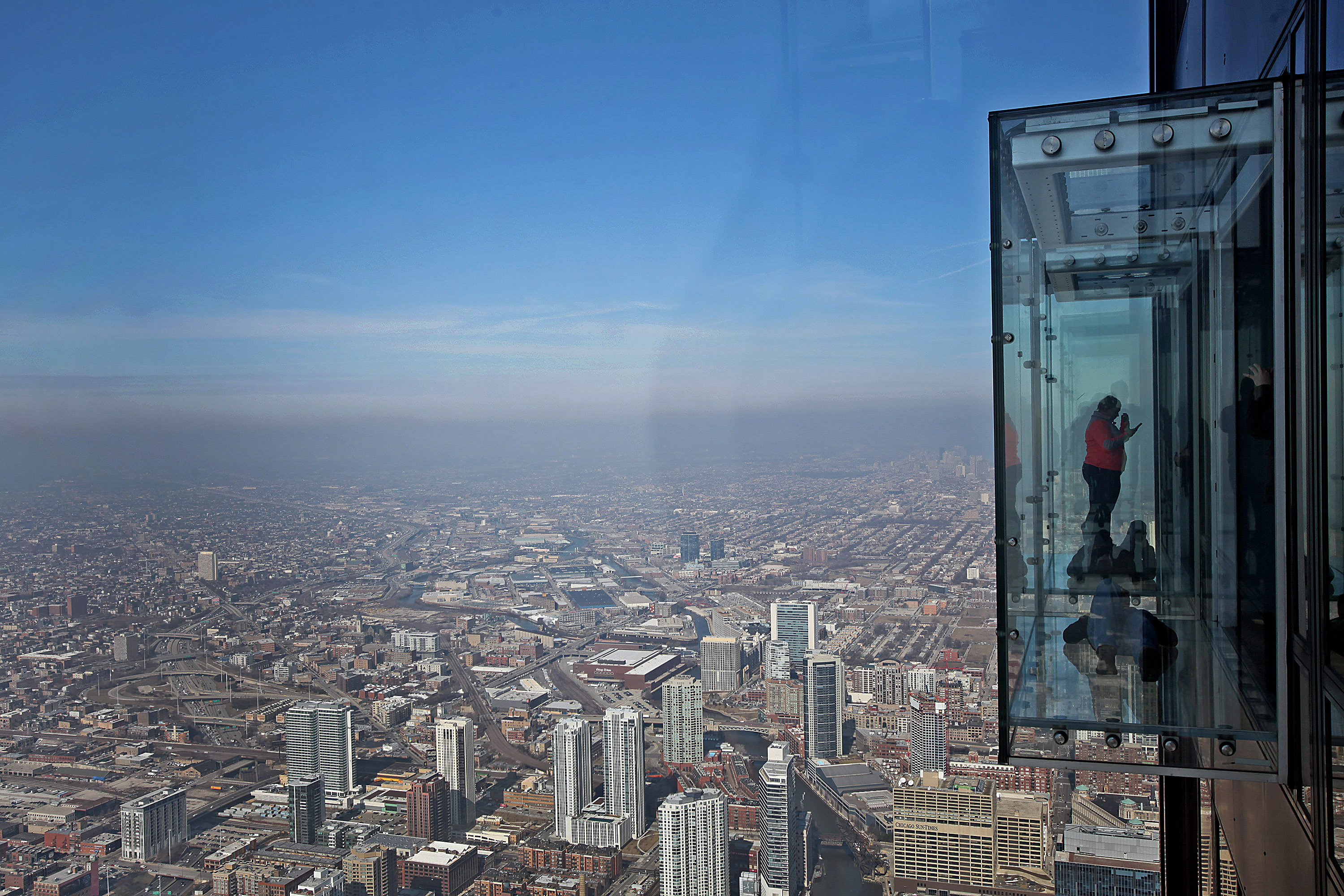 Visitors stand on the glass balcony at the skydeck of the Willis Tower in Chicago, Illinois, U.S., on Wednesday, Feb. 13, 2013. (Bloomberg/Getty Images)