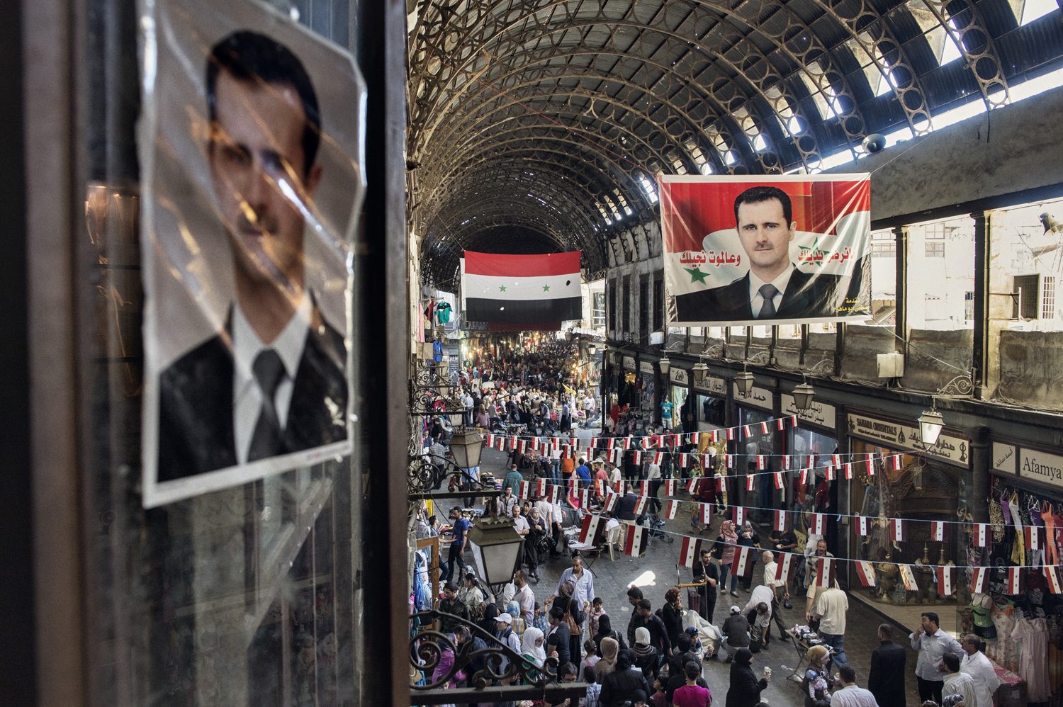 Election banners promoting Assad in upcoming presidential elections, in Damascus' covered market, May 15, 2014.