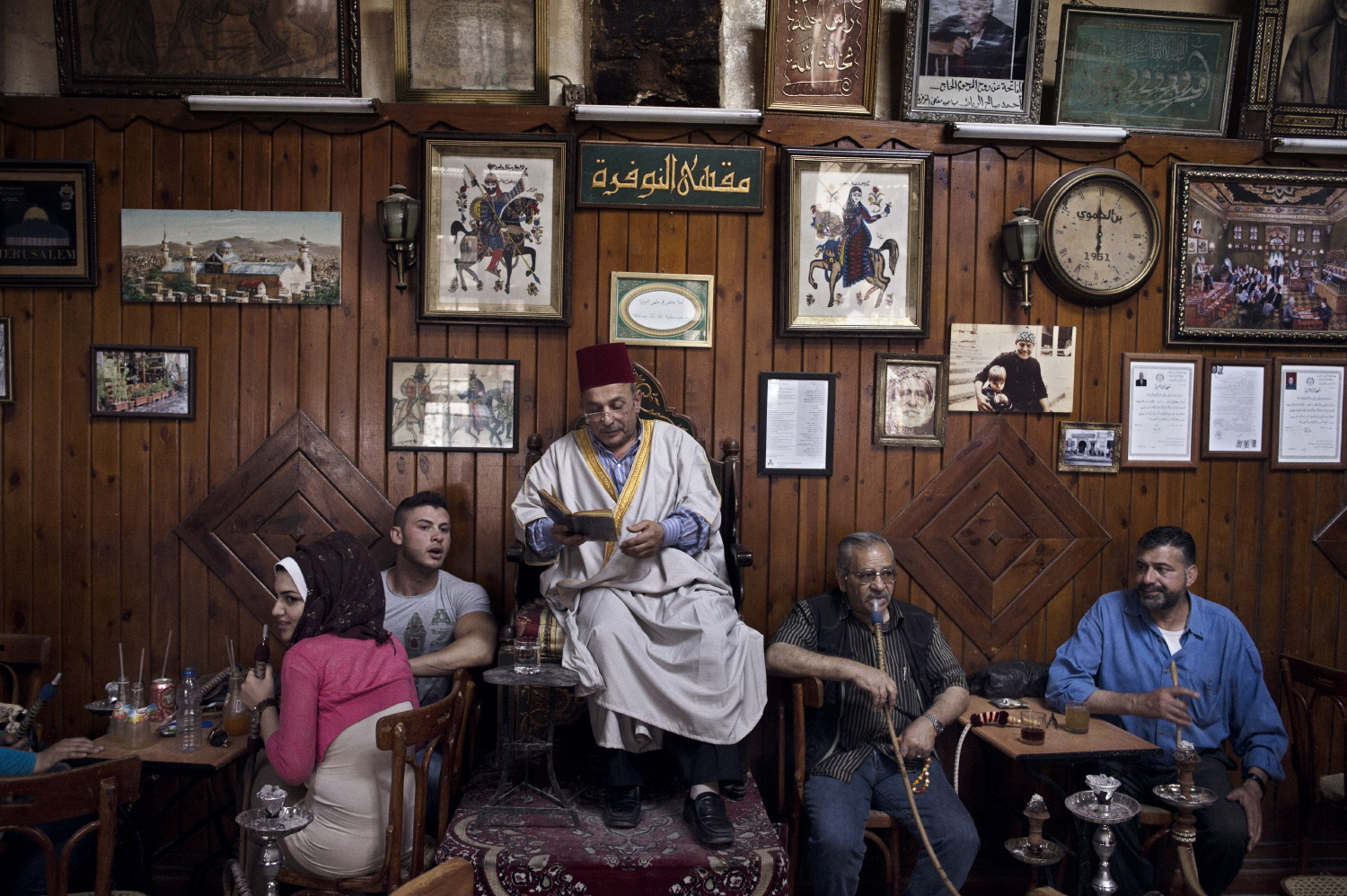 At the al Nawfara coffee shop in the old city of Damascus, professional story teller Abu Shaadi entertains patrons by reading traditional tales of old Syria, May 15, 2014.