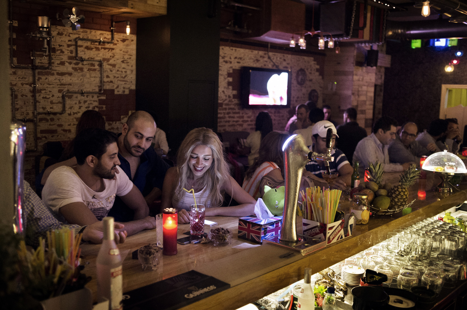 Recently engaged couple Rama, 27, and Razooq, 31,L, share a drink at Damascus' recently opened Upstairs Bar. May 16, 2014.