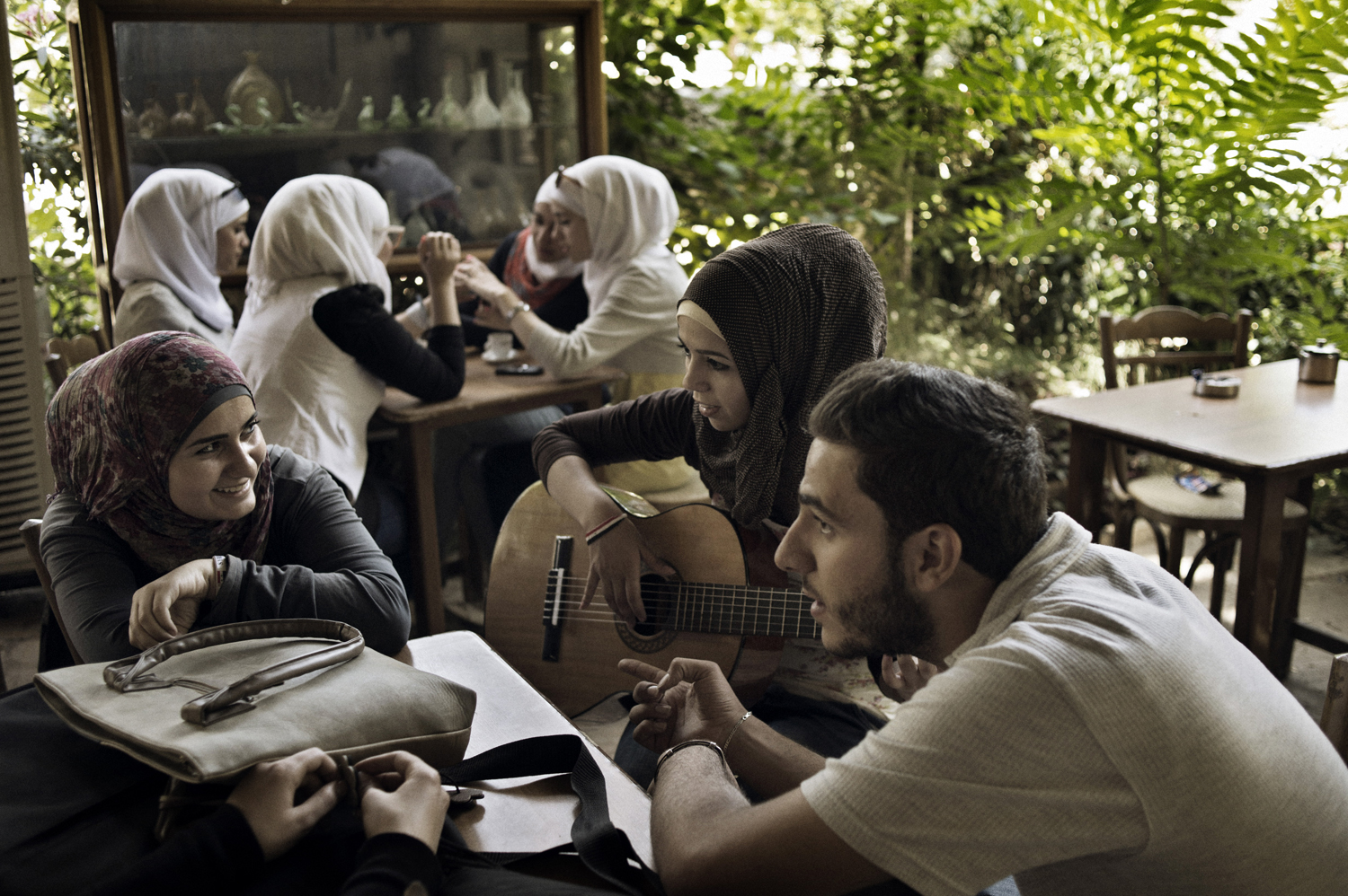 Young Damascenes gather at the café in the garden of the National Museum in Damascus, May 18, 2014.