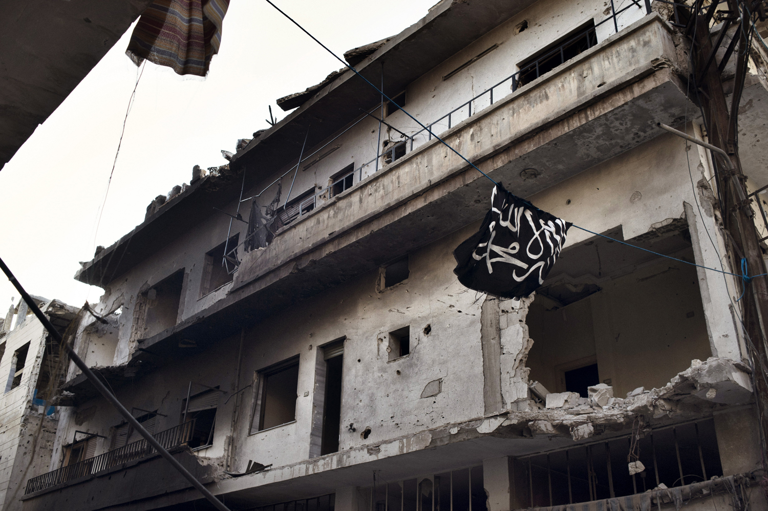 Qaeda's flag is seen flying at the Qarabis neighborhood in the Old City of Homs, May 12, 2014.