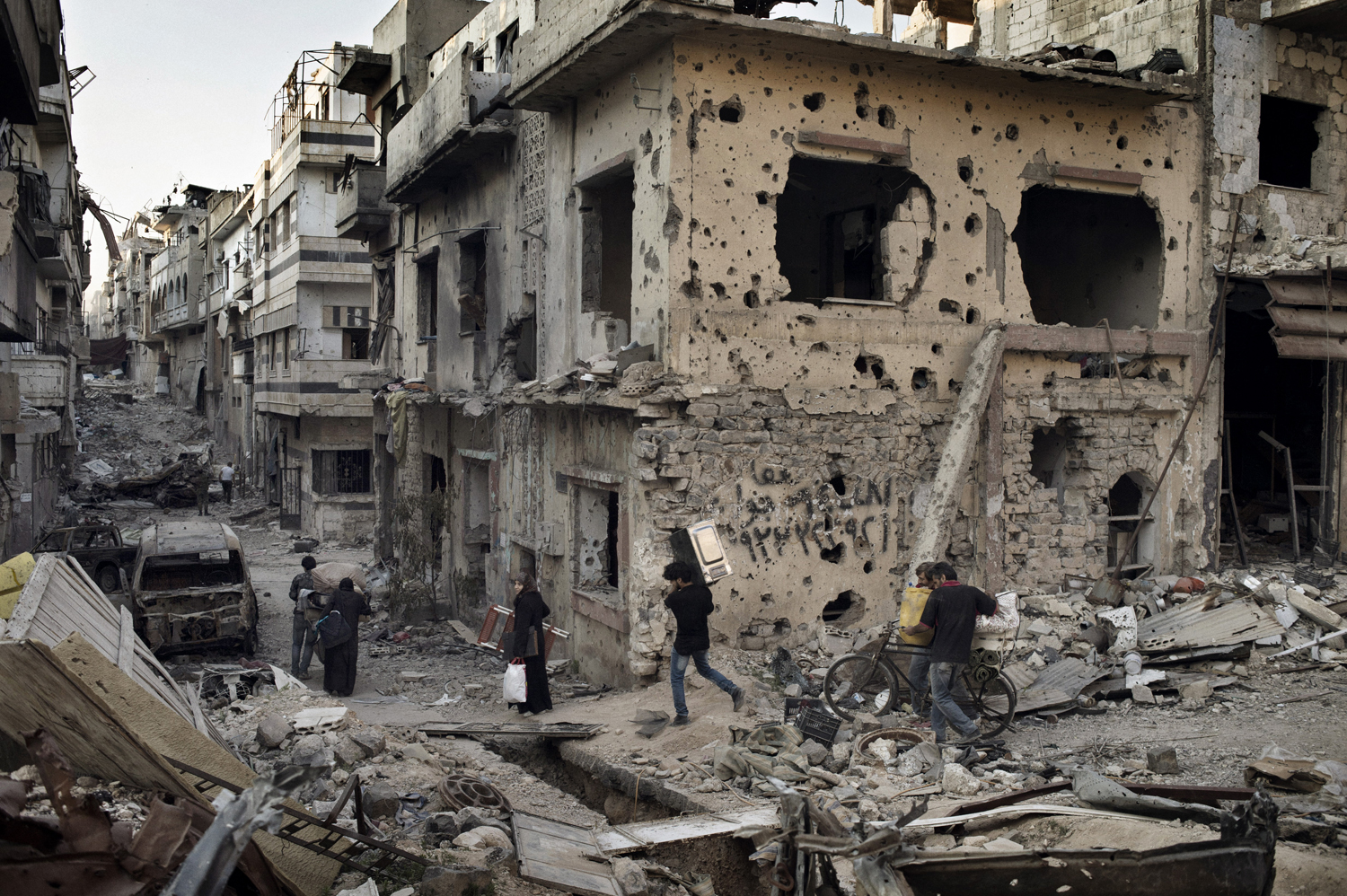 In the wake of a cease-fire, residents of Homs reclaim belongings from their devastated homes. May 12, 2014.
