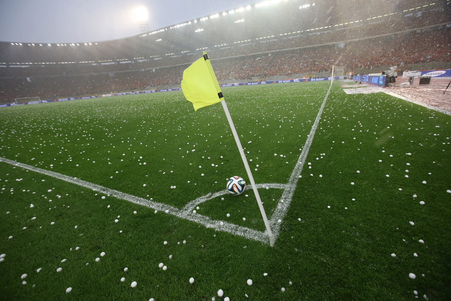 Pellets of ice are scattered on the pitch after the hailstorm that interrupted the international friendly soccer match between Belgium and Tunisia at King Baudoin stadium in Brussels on June 7, 2014.