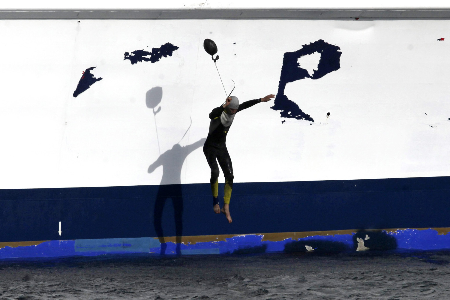 An illegal Moroccan immigrant jumps into the water from the ferry 'Detroit Jet' covering the Tangiers-Tarifa route, upon its arrival to Tarifa, in the southern province of Cadiz, Spain on June 12, 2014.