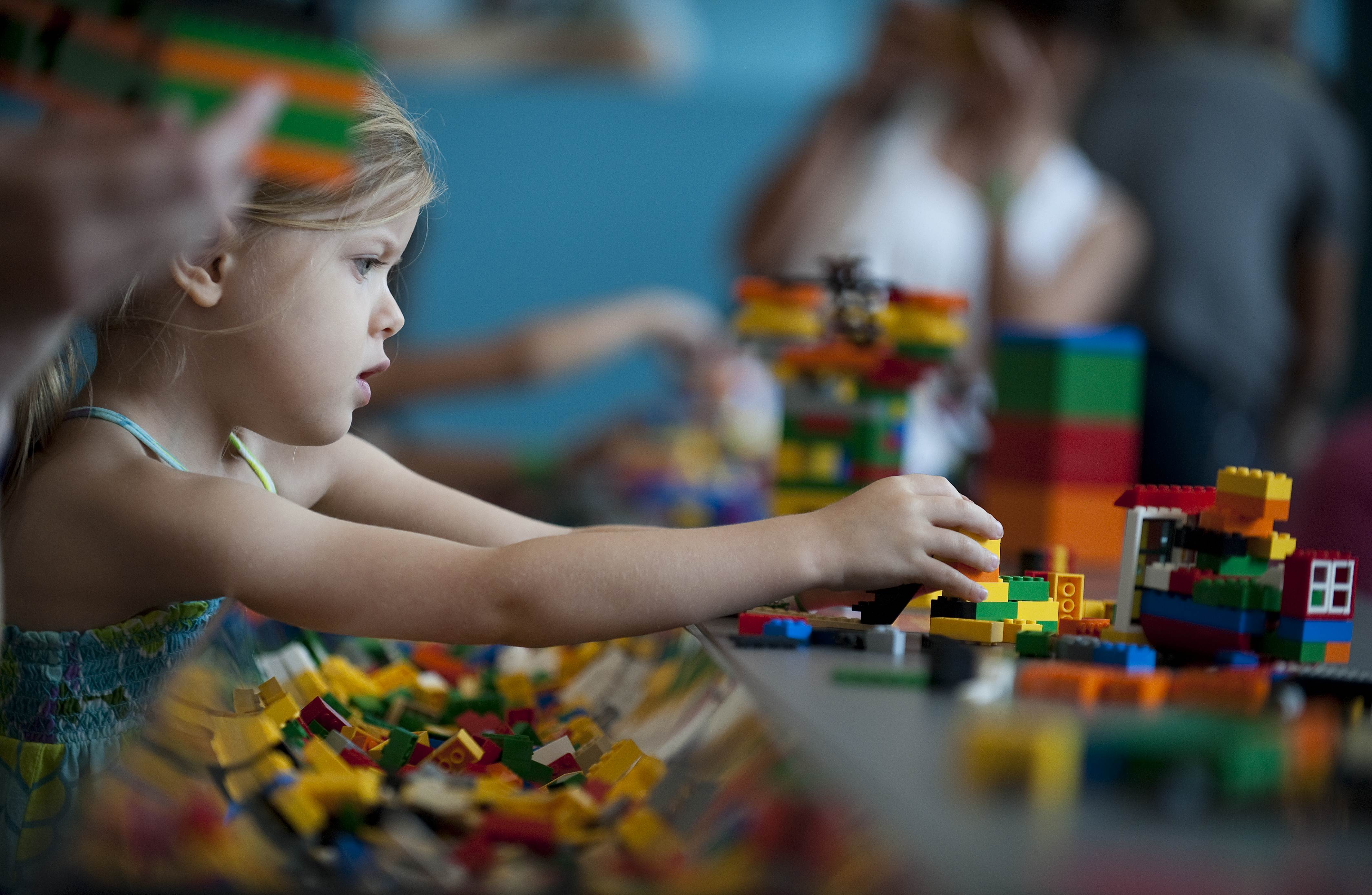 A child plays with Lego building blocks