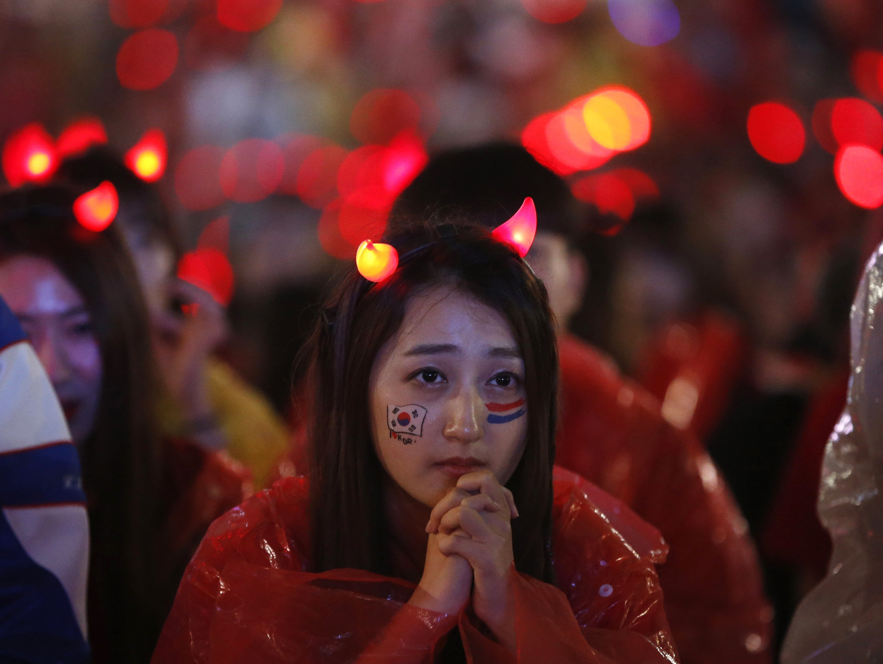 A South Korean fan watches a live TV broadcast of her team's 2014 World Cup Group H match against Algeria, in Seoul on June 23, 2014.