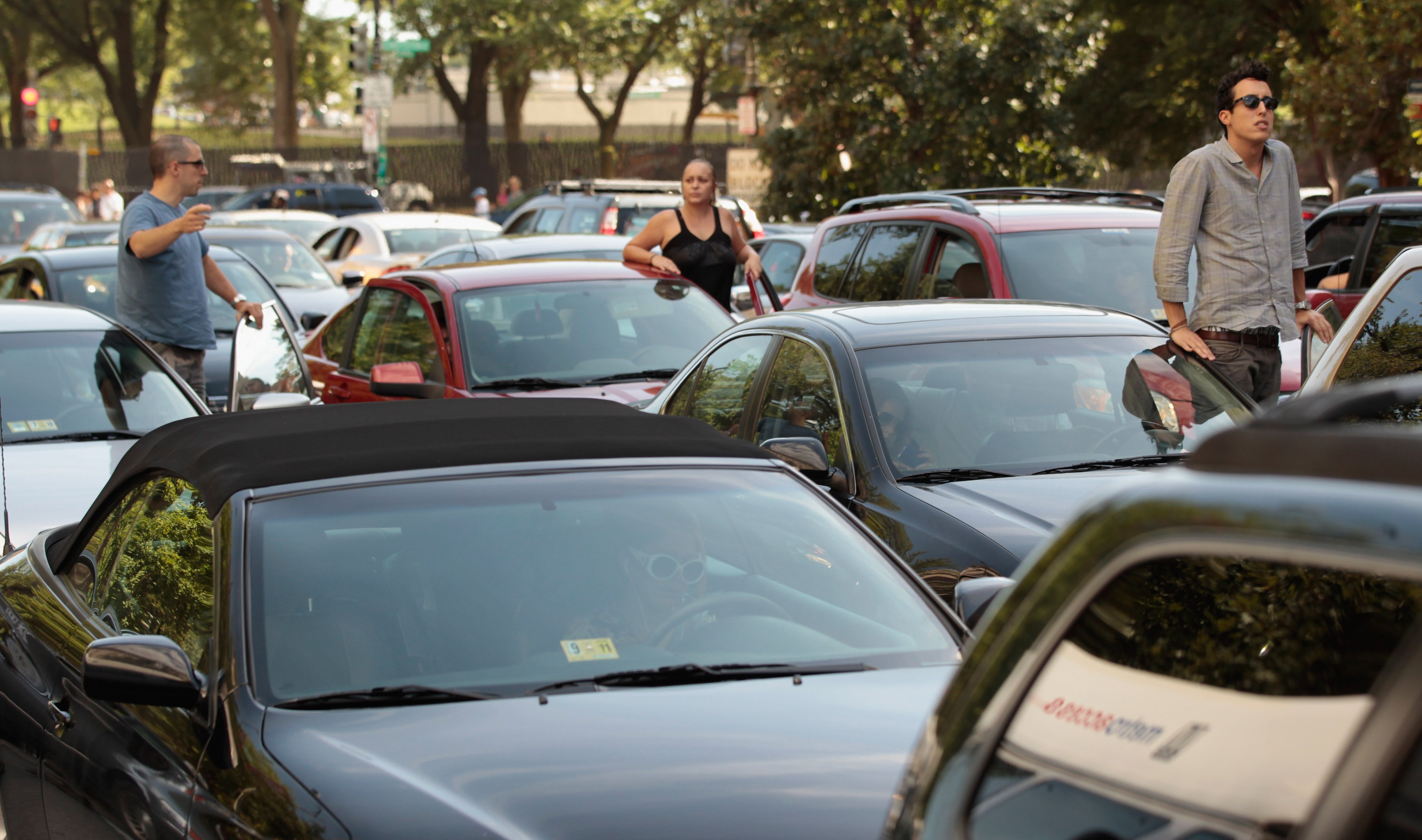 Drivers climb out of their cars to survey a traffic jam on August 23, 2011 in Washington D.C. (Chip Somodevilla—Getty Images)