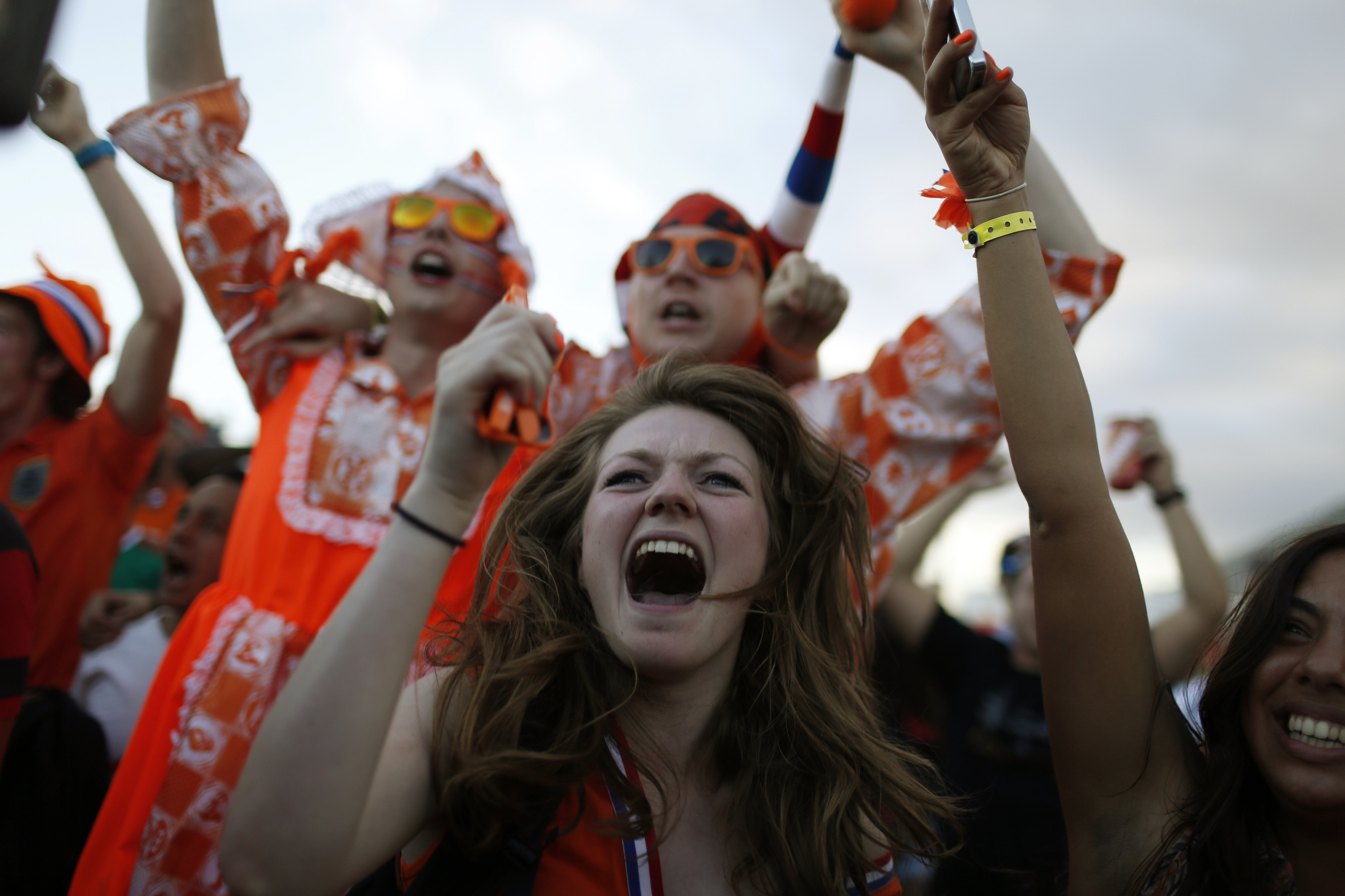 Dutch soccer fans celebrate a goal as they watch a broadcast of the match between the Netherlands and Spain on a large screen at Copacabana beach in Rio de Janeiro on June 13, 2014.