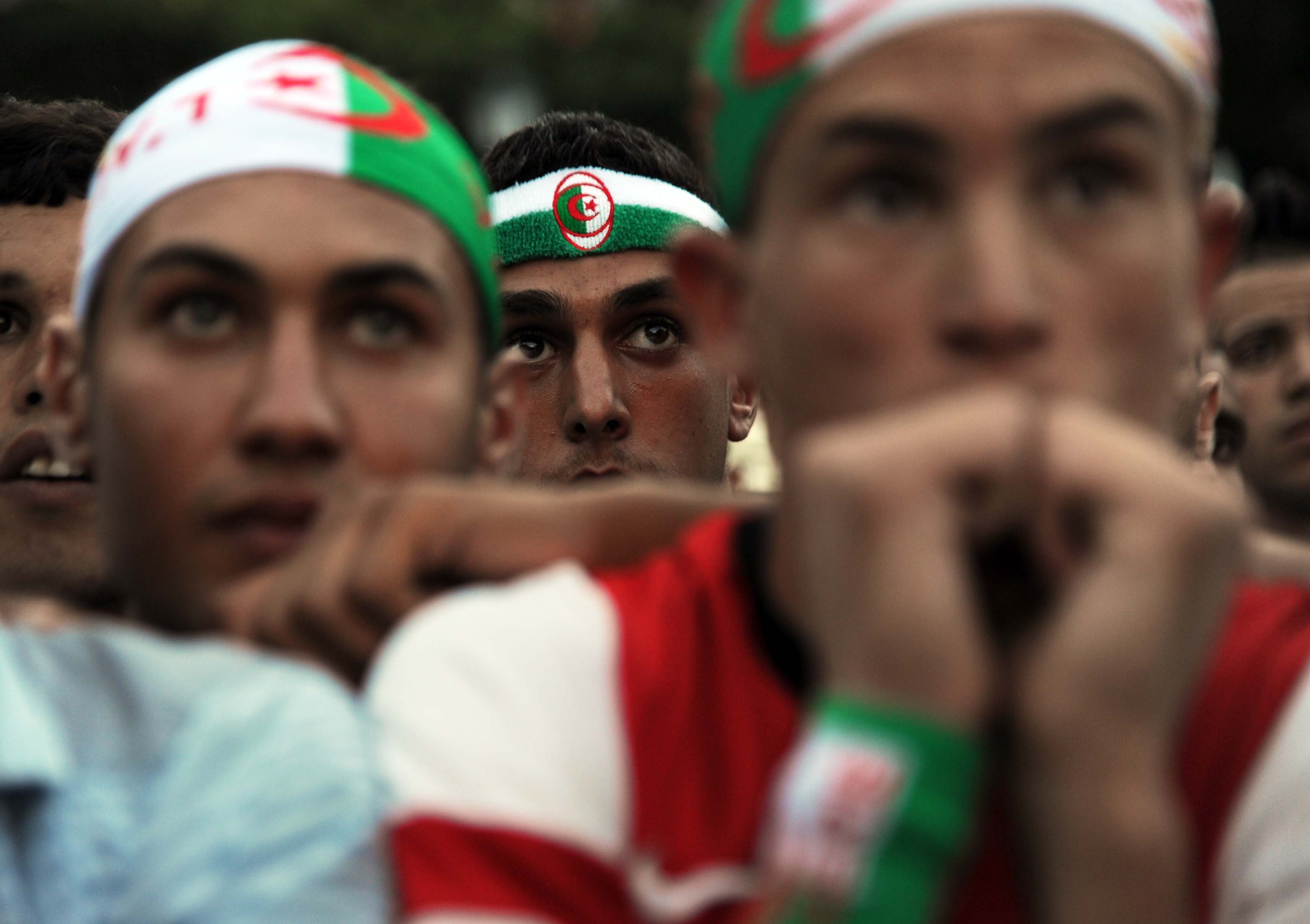 Algeria's fans react as they watch the match between Algeria and South Korea on a big screen in central Algiers, on June 22, 2014.