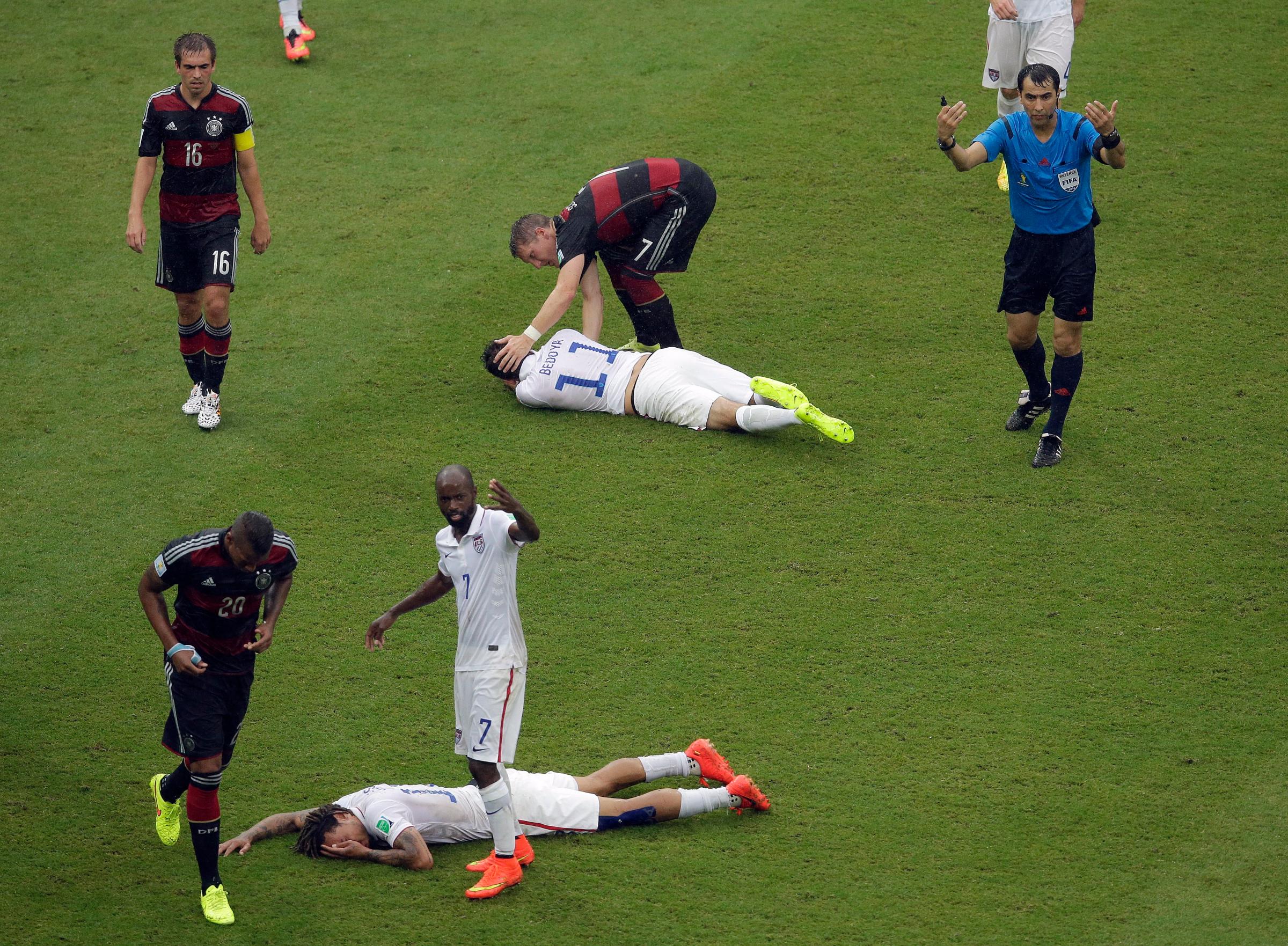 United States' Jermaine Jones, foreground, and United States' Alejandro Bedoya lie injured after colliding with each other at the Arena Pernambuco in Recife, Brazil on June 26, 2014.