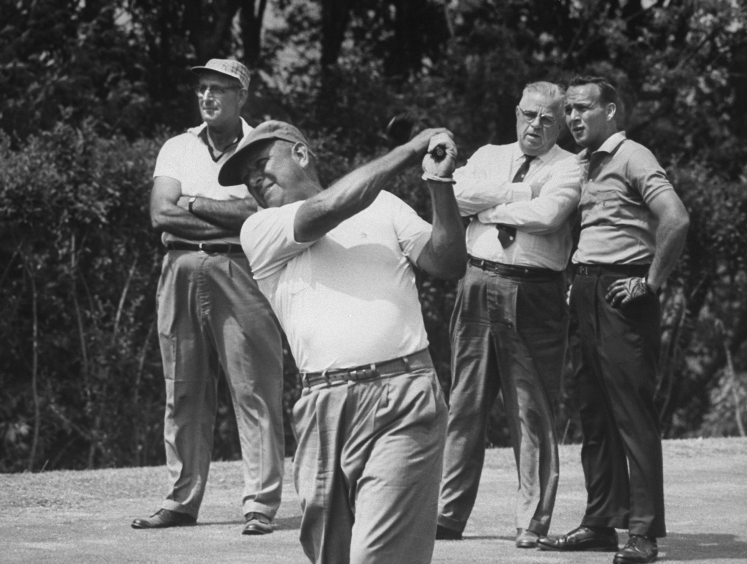 In father-and-son match Arnold waits while Milfred Palmer, his first teacher tees off at Oakmont, Pa. Country Club" in 1962.