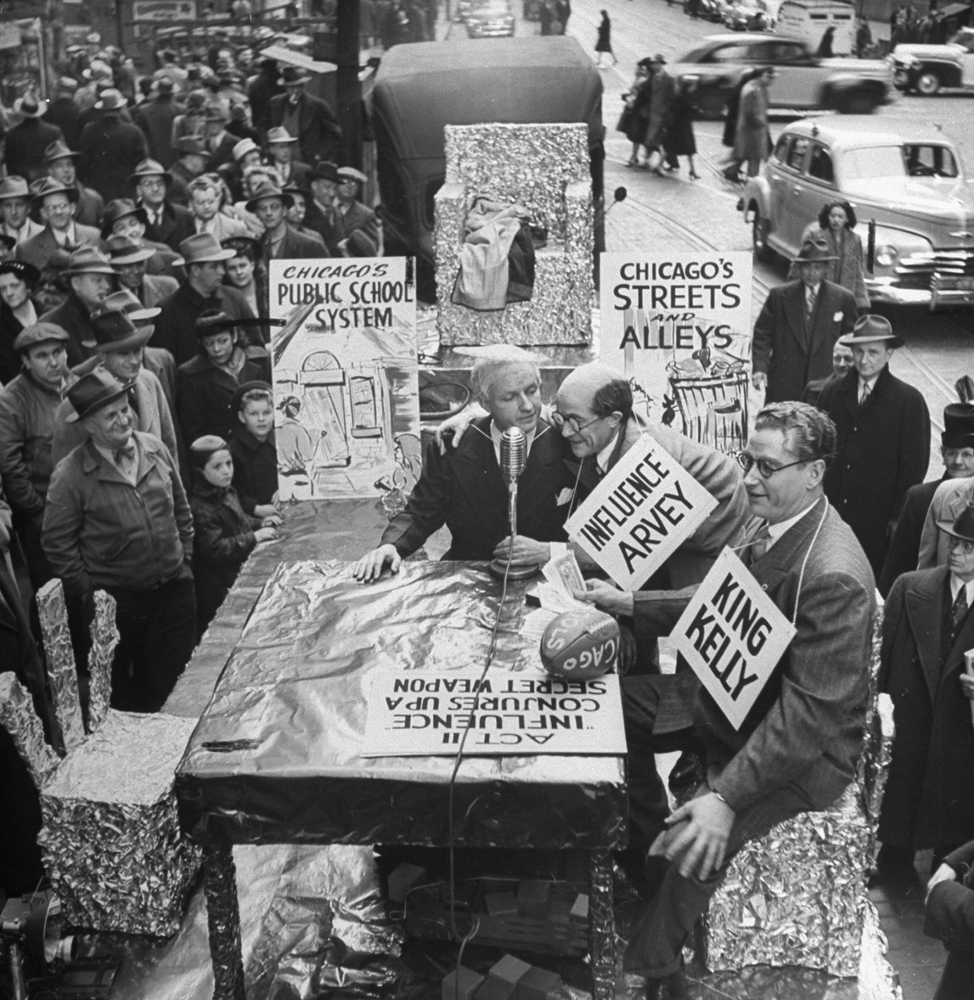People gathering on the street to watch a satire of political officials, Chicago, 1947.