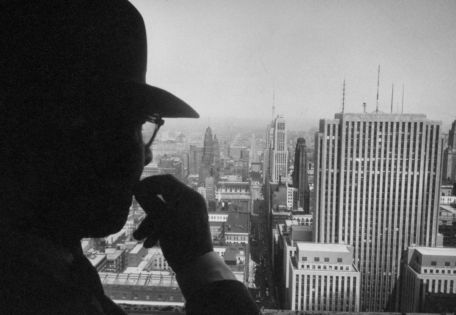 Poet Carl Sandburg looks out a window in the Chicago Board of Trade Building, 1957.