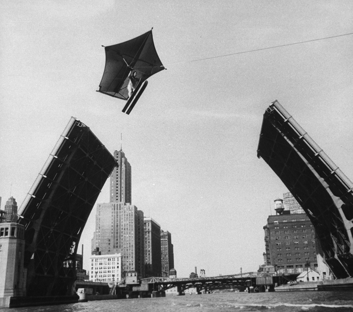 Stunt man Jack Wylie flying over the Chicago River, 1958.