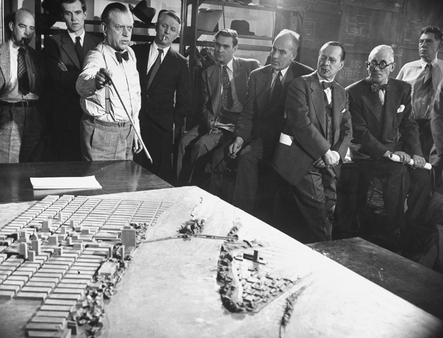 Canadian Ernest Cormier (white shirt, bow tie) and an international team of architects discuss the new United Nations headquarters in New York City, 1947.