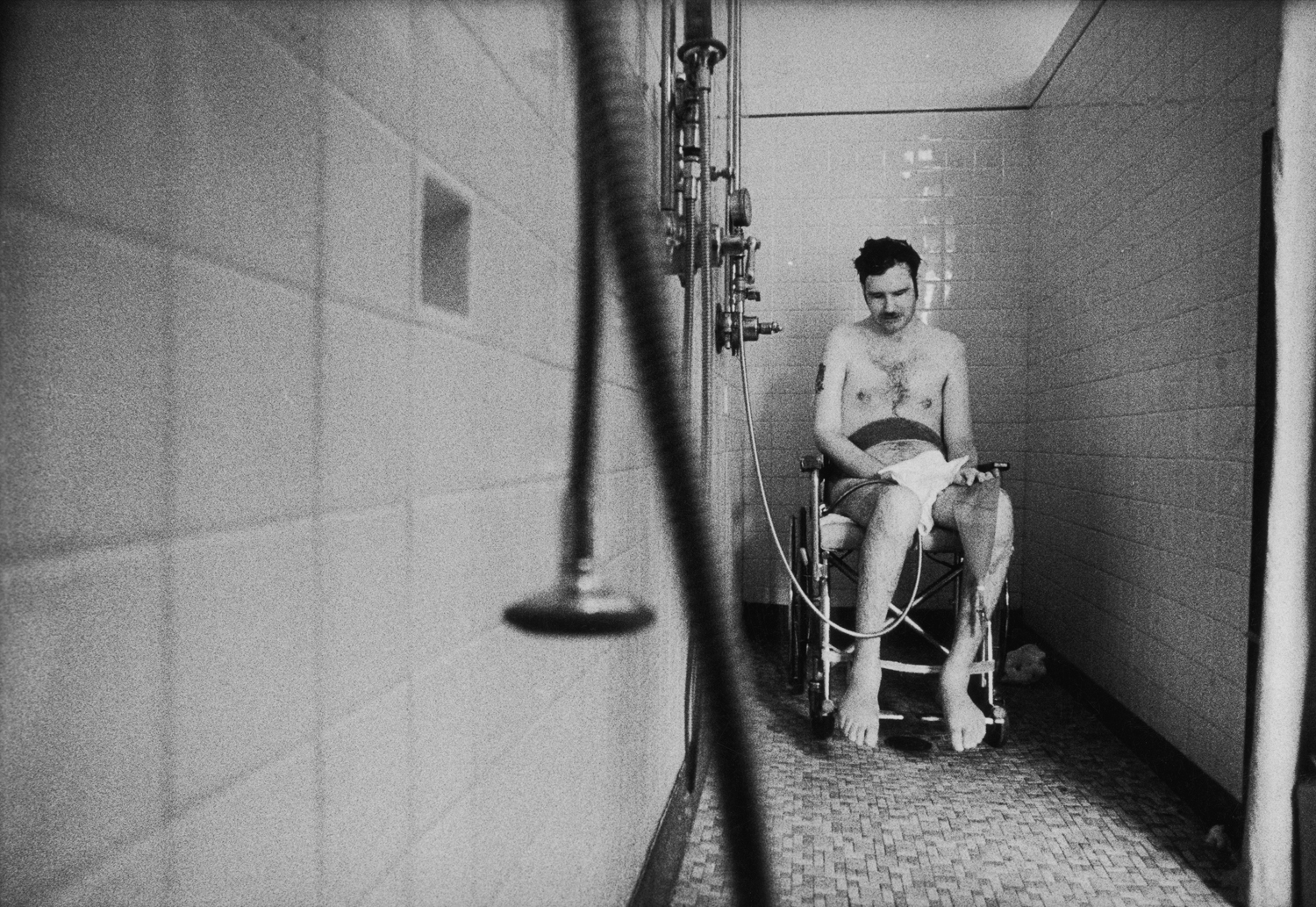 Quadriplegic Marke Dumpert, invalided out of the Marines as a lance corporal, waits helplessly to be dried in a veterans' hospital.