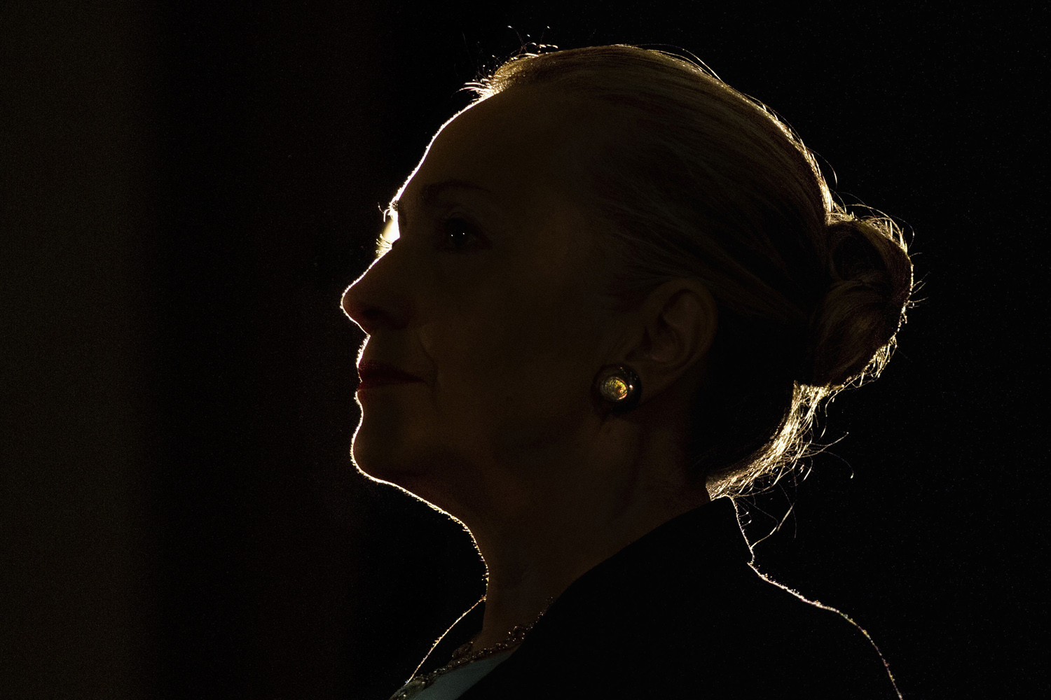 Silhouetted by a stage light, Secretary of State Hillary Rodham Clinton speaks at the University of the Western Cape about U.S.-South Africa partnership, Wednesday, Aug. 8, 2012, in Cape Town, South Africa. (AP Photo/Jacquelyn Martin, Pool)