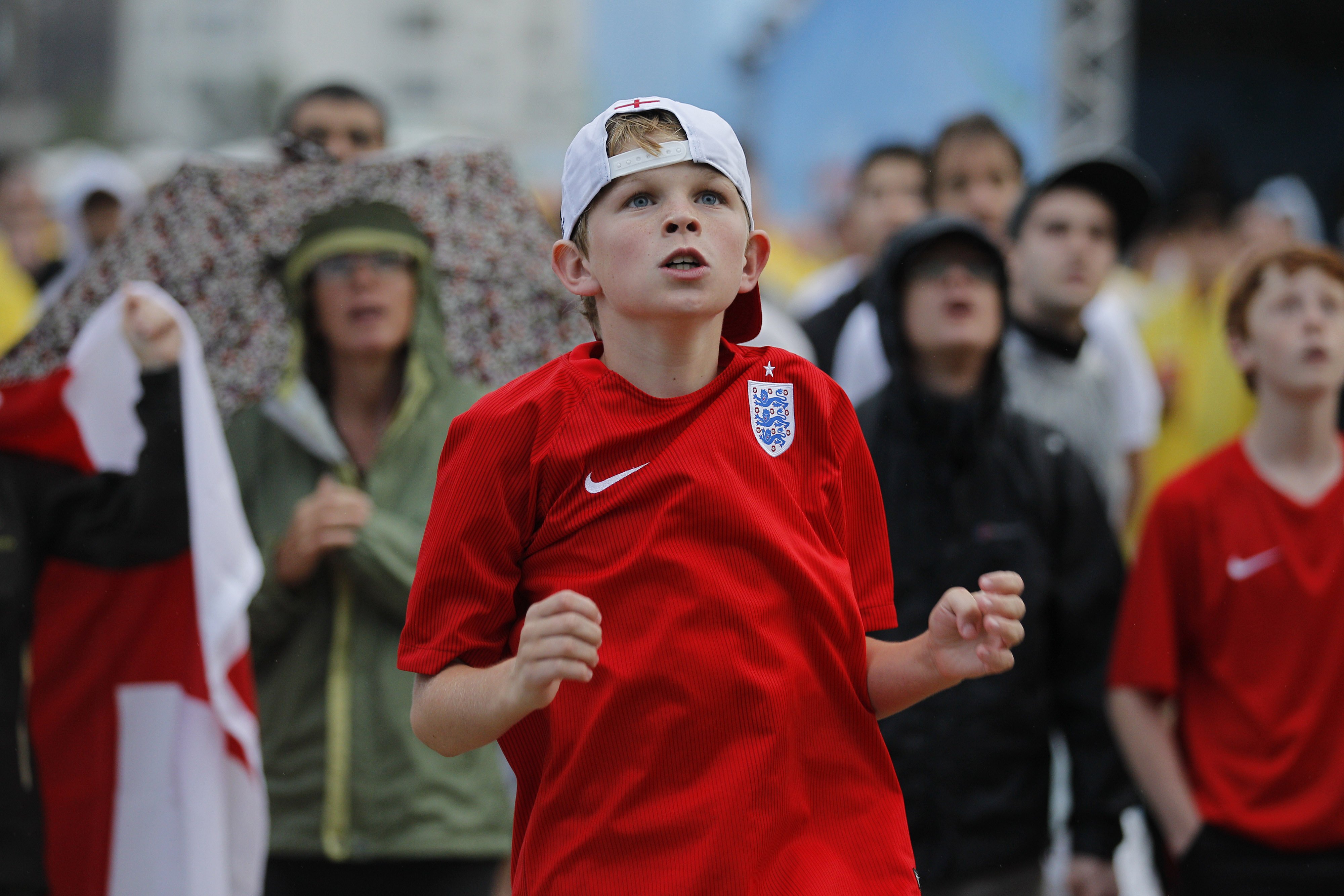 A young England fan watches a live telecast of the group D match between Uruguay and England, inside the FIFA Fan Fest area on Copacabana beach, in Rio de Janeiro on June 19, 2014.
