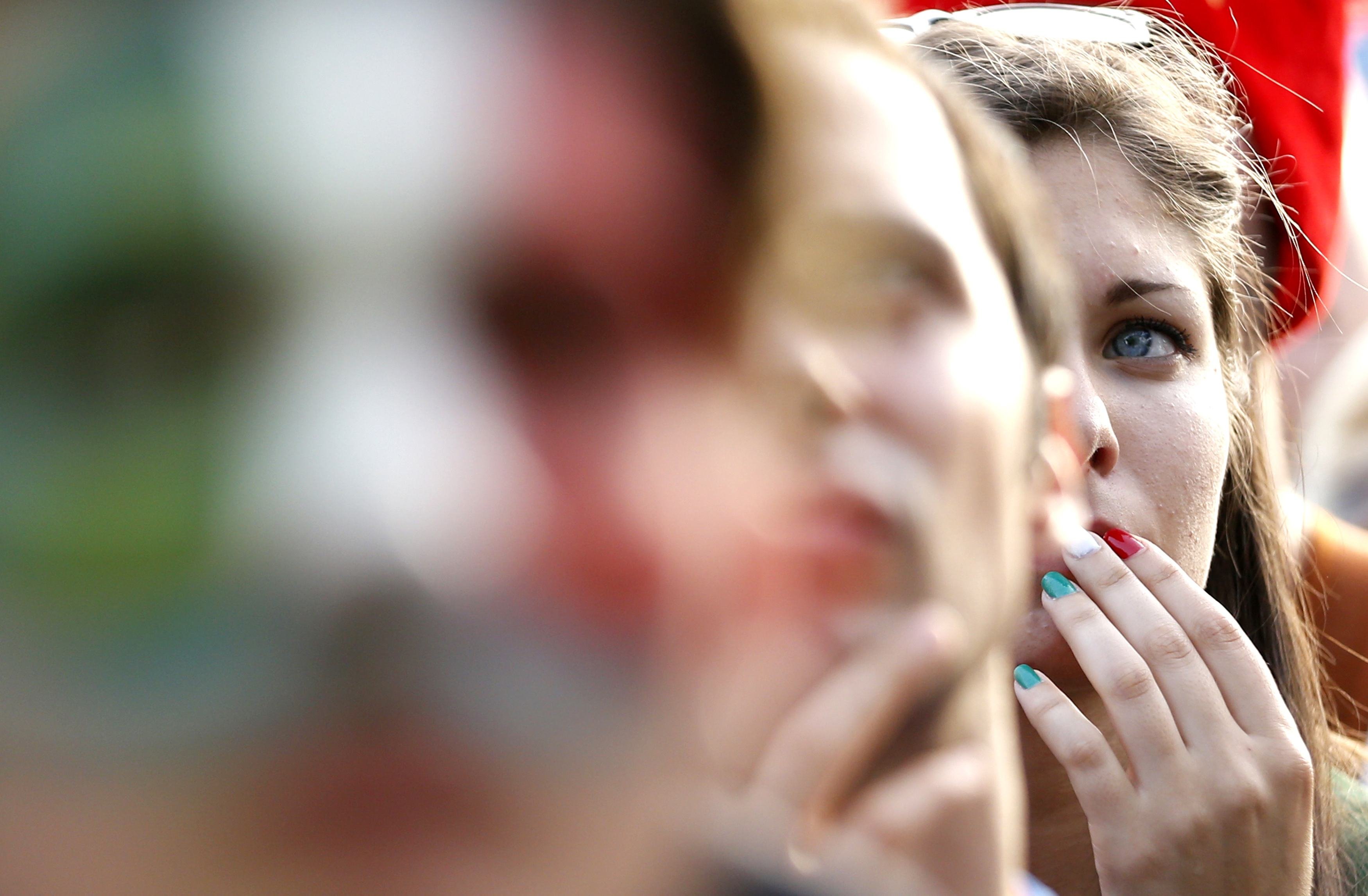 A fan reacts as she watches the match between Italy and Uruguay, in Rome on June 24, 2014.