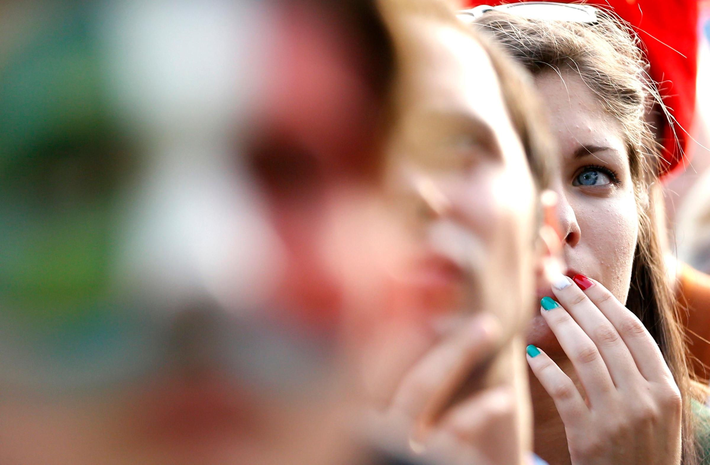 A fan reacts as she watches the 2014 World Cup soccer match between Italy and Uruguay, in Rome on June 24, 2014.