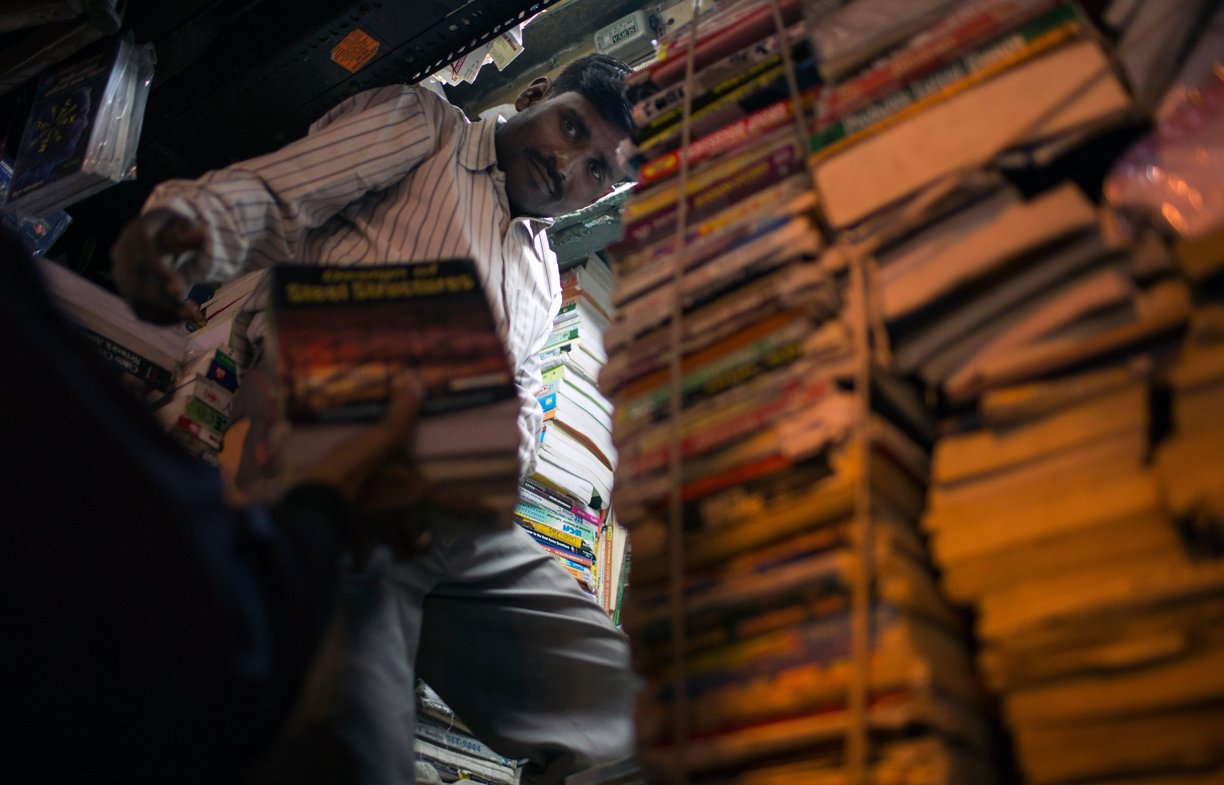 An Indian book vendor arranges items at his shop in New Delhi's Old Quarter on Jan. 30, 2013. (AFP—AFP/Getty Images)