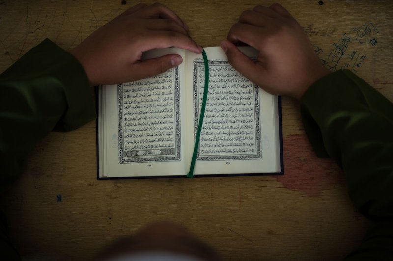 A Muslim boy reads the Koran during the month of Ramadan, Kuala Lumpur, July 30, 2013.