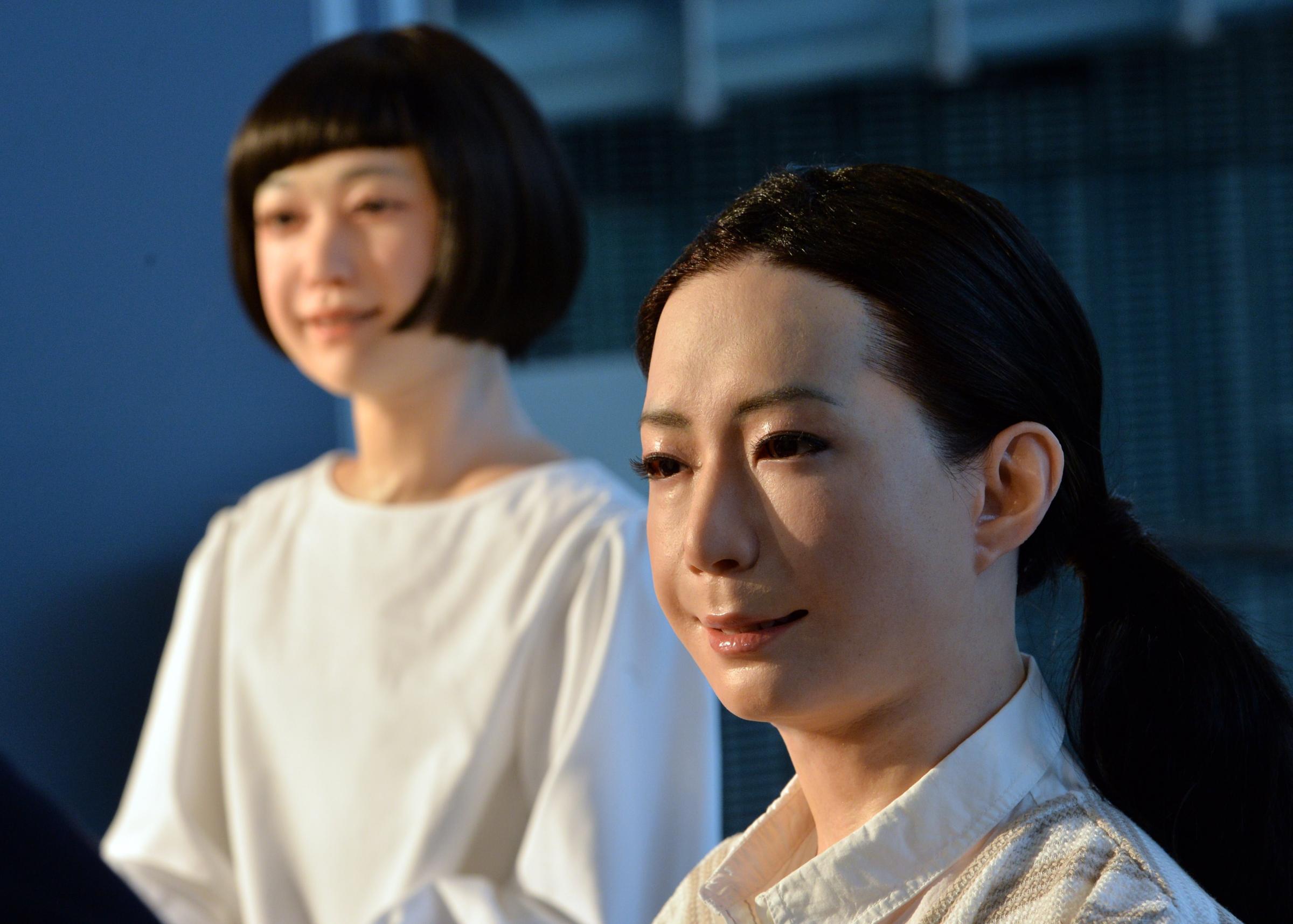 The new humanoid robots named "Otonaroid" and "Kodomoroid" are pictured during a press preview at the National Museum of Emerging Science and Technology in Tokyo on June 24, 2014.