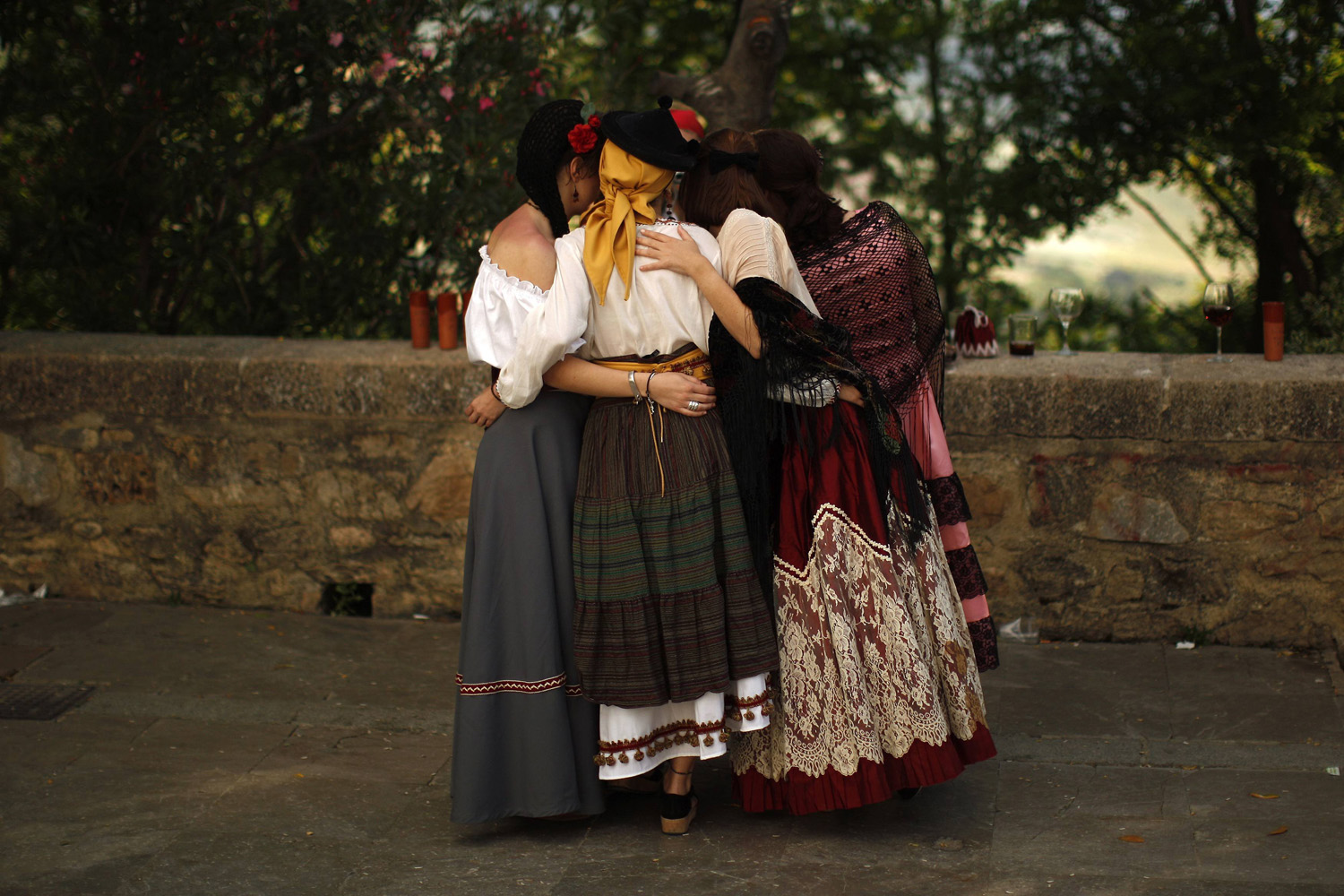 Women wearing traditional costumes are photographed by a friend during the second edition of "Ronda Romantica" (Romantic Ronda) in Ronda