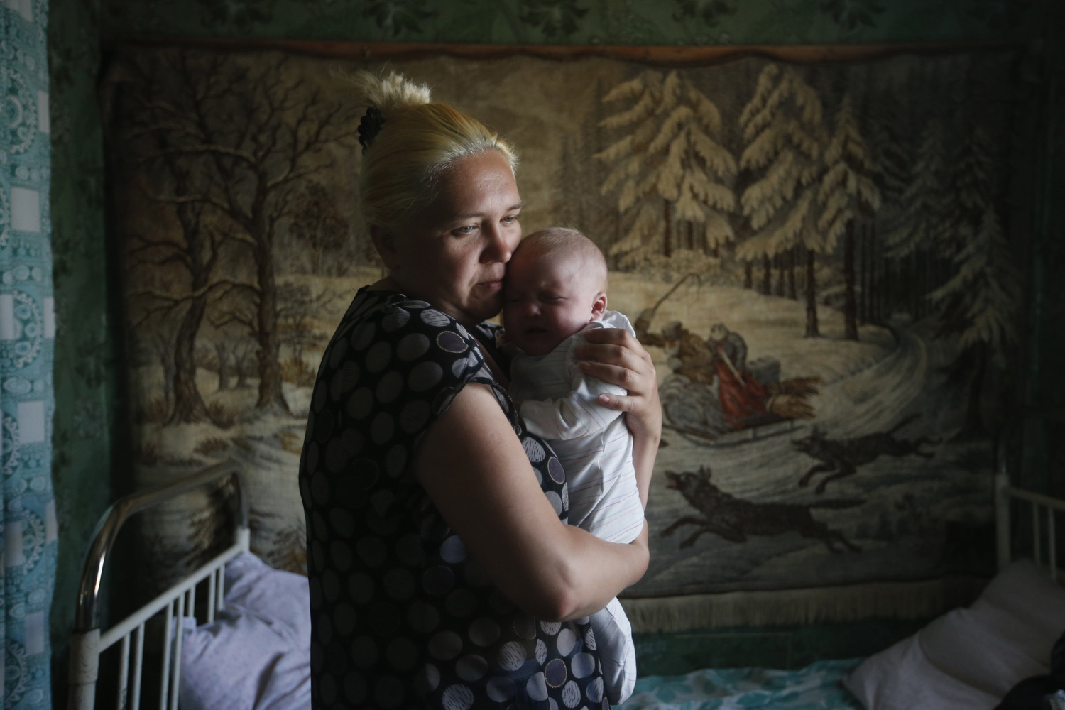 A mother and child who have fled from fighting in Slaviansk, stand in their temporary accommodation in the town of Nizhnaya Krinka
