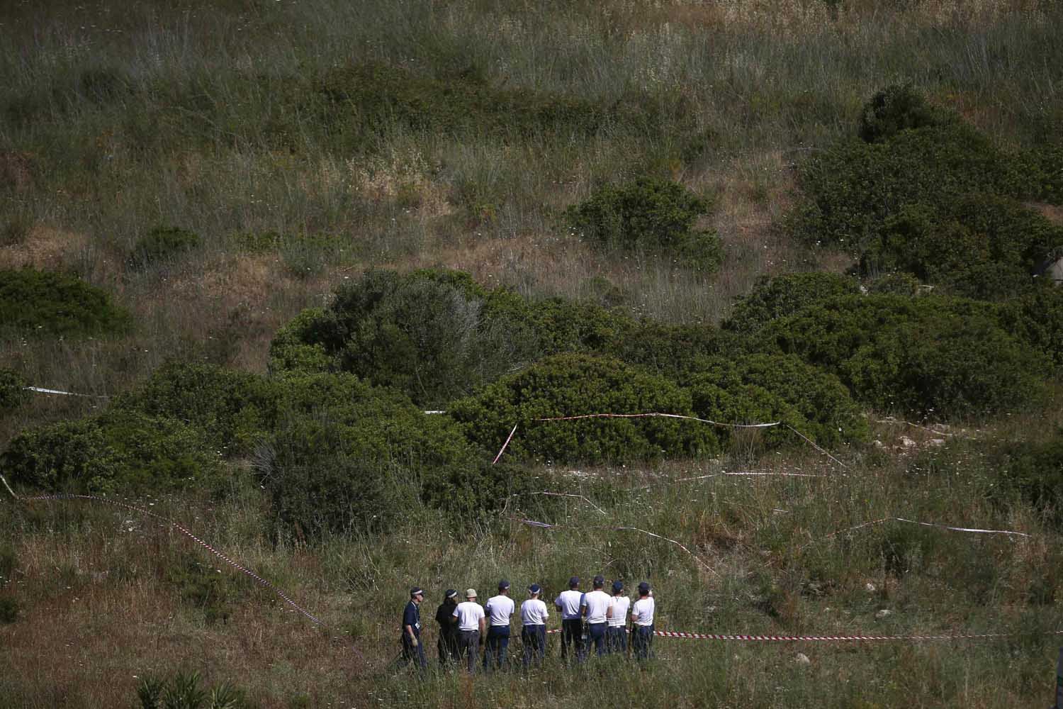 Members of Scotland Yard work at an area during the search for missing British girl Madeleine McCann in Praia da Luz