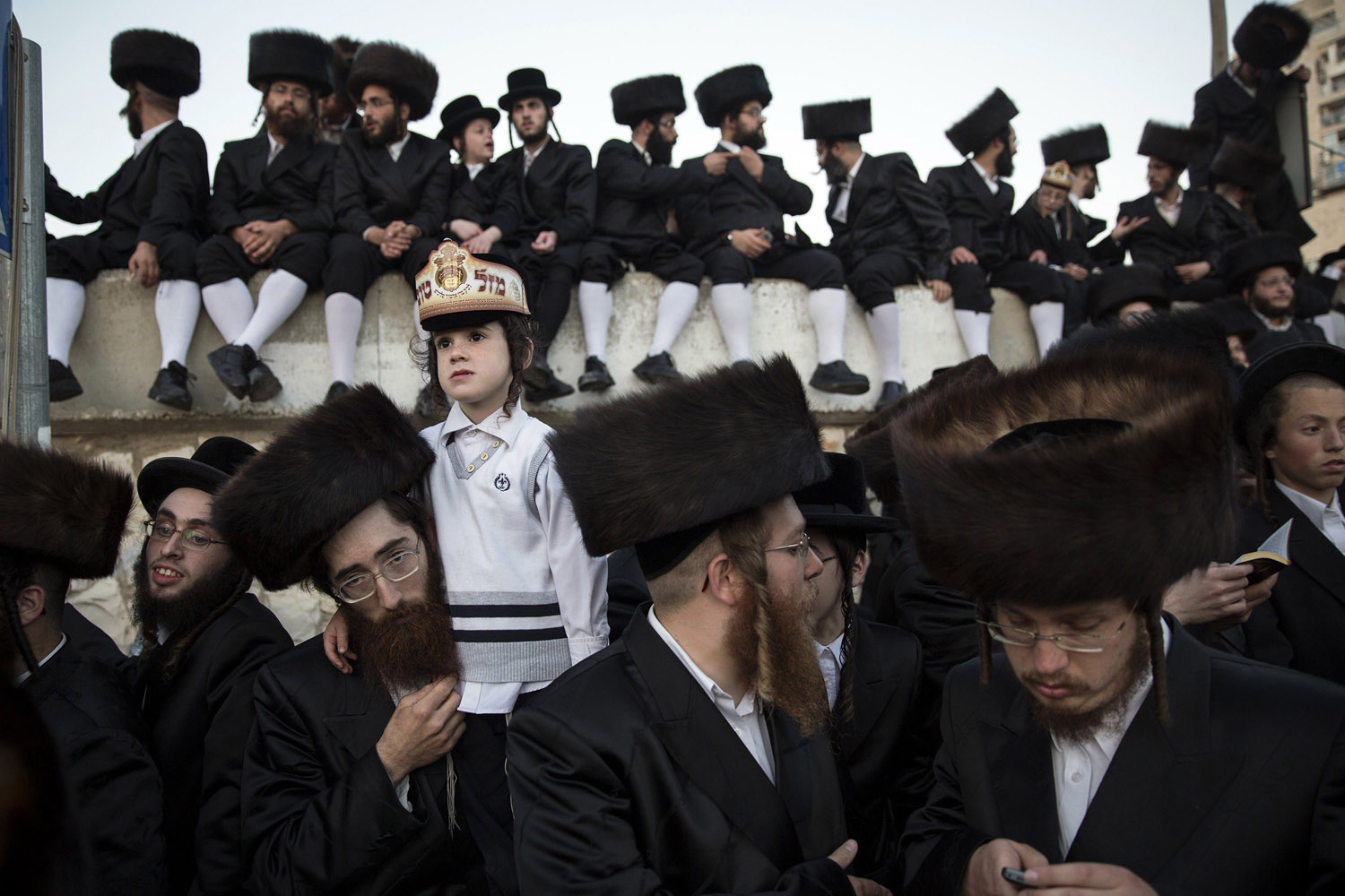 Ultra-orthodox Jews watch a wedding ceremony in Jerusalem