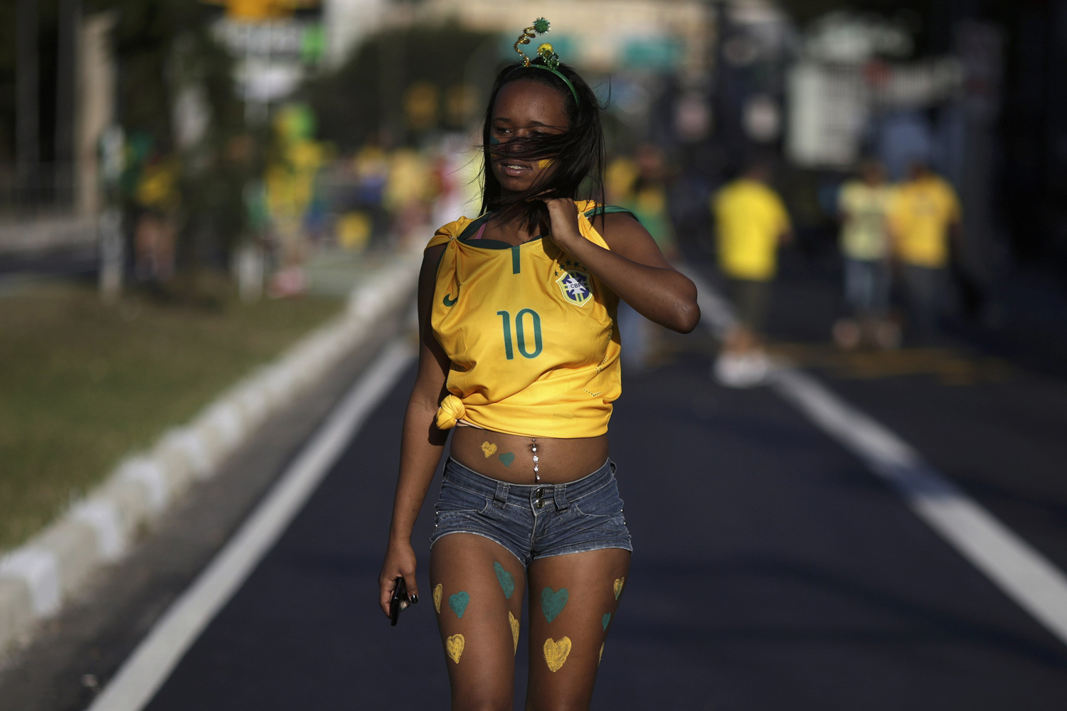 A brazilian soccer fan walks on the street near the Corinthians Arena ahead the 2014 World Cup match between Brazil and Croatia in Sao Paulo