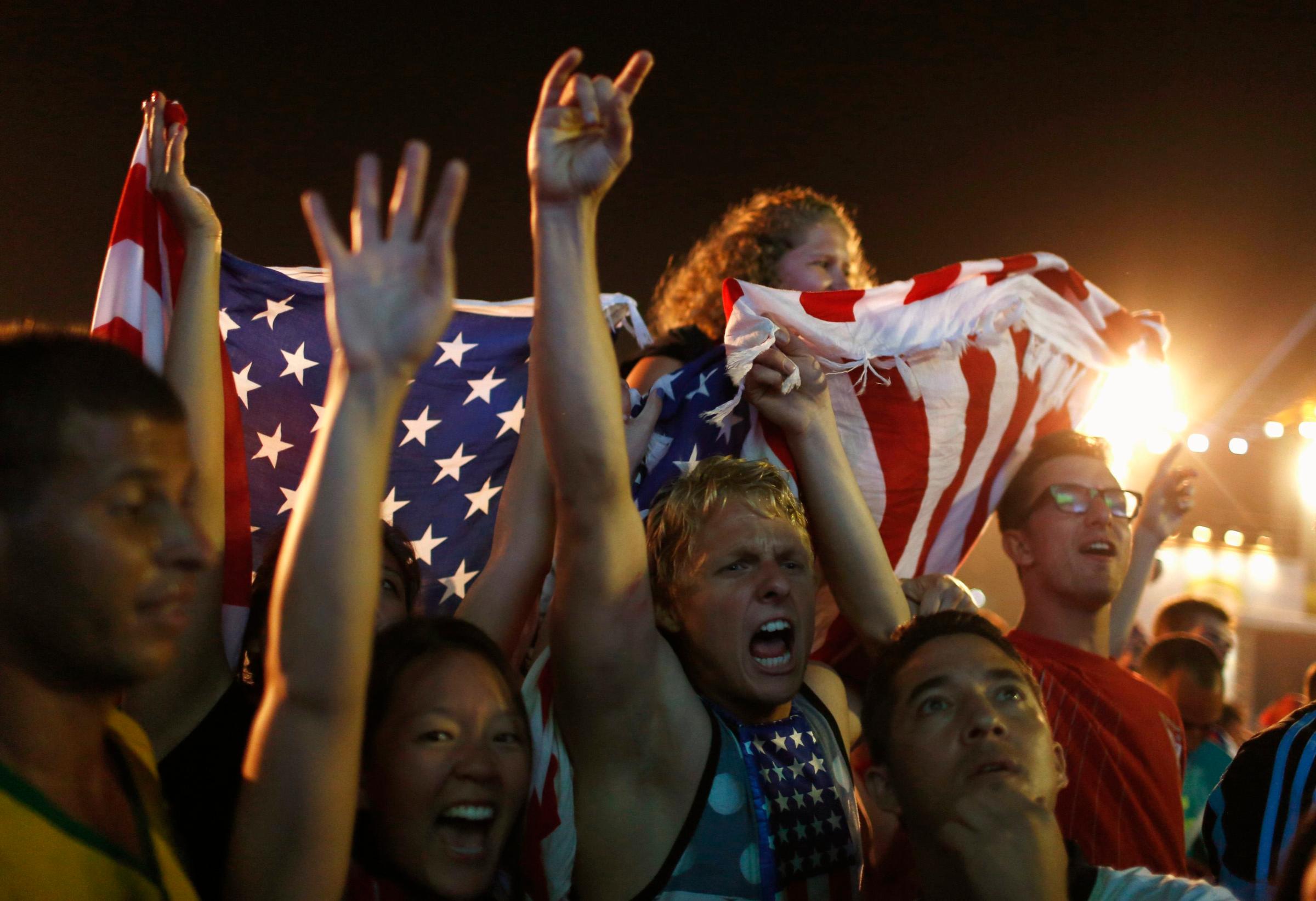 U.S. soccer fans celebrate at the end of the 2014 World Cup soccer match between U.S. and Ghana, which was broadcast on a large screen at Copacabana beach, in Rio de Janeiro