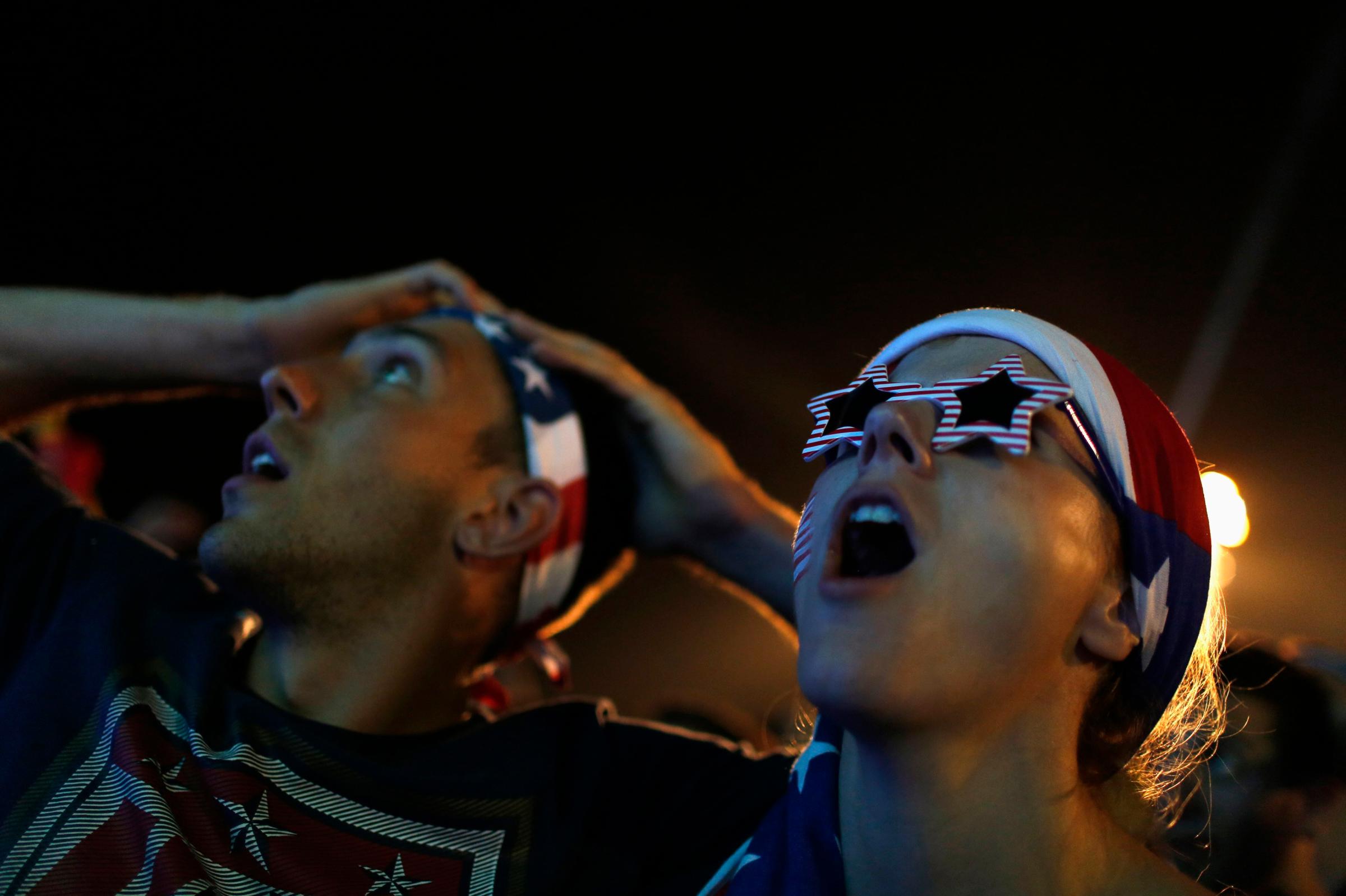 U.S. soccer fans react  as they watch the 2014 World Cup soccer match between U.S. and Ghana, which is broadcast on a large screen at Copacabana beach, in Rio de Janeiro
