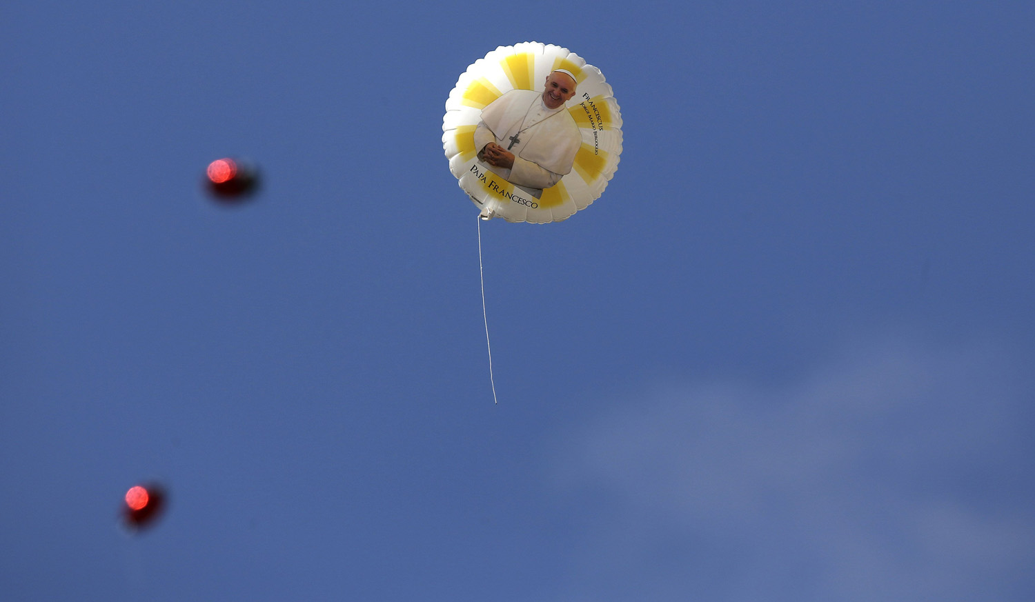 A balloon with an image of Pope Francis flies during a weekly general audience leads by the pope at St. Peter's Square at the Vatican