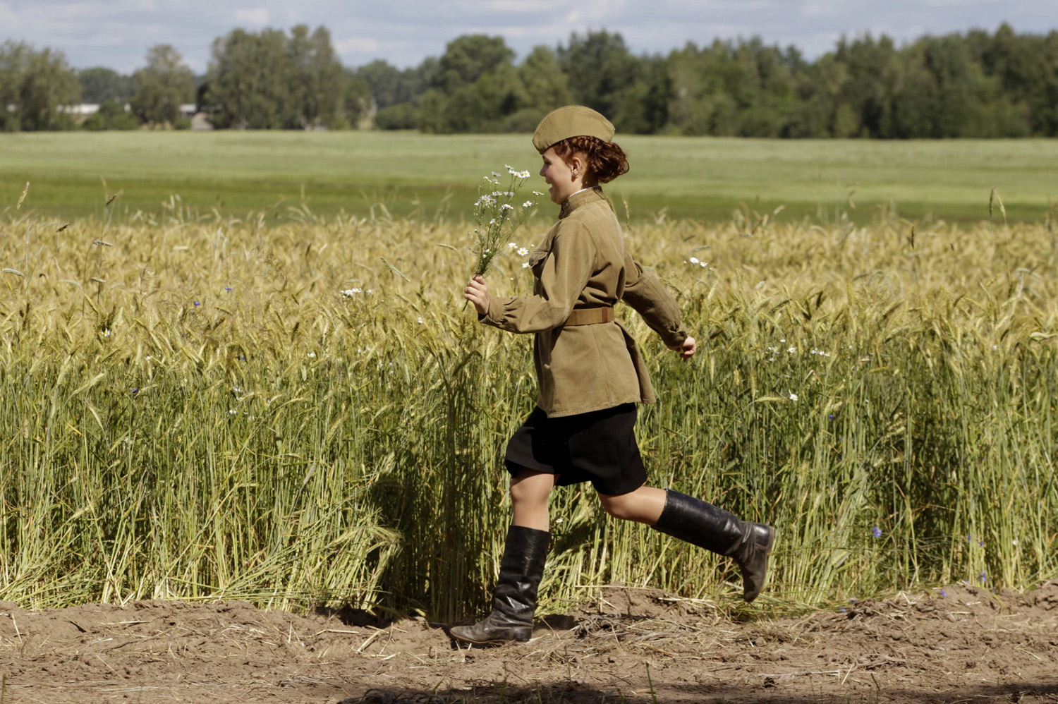 Woman, dressed in World war II costume, runs near the village of Rakovichi