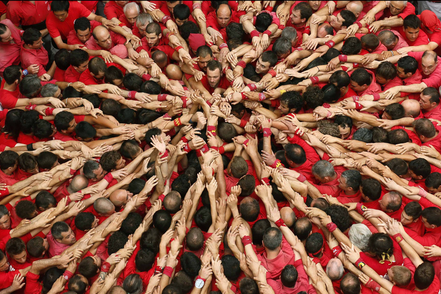 Jun. 24, 2014. Castellers Colla Joves Xiquets de Valls start to form a human tower called  castells  during the Sant Joan festival at Plaza del Blat square in Valls, south of Barcelona.