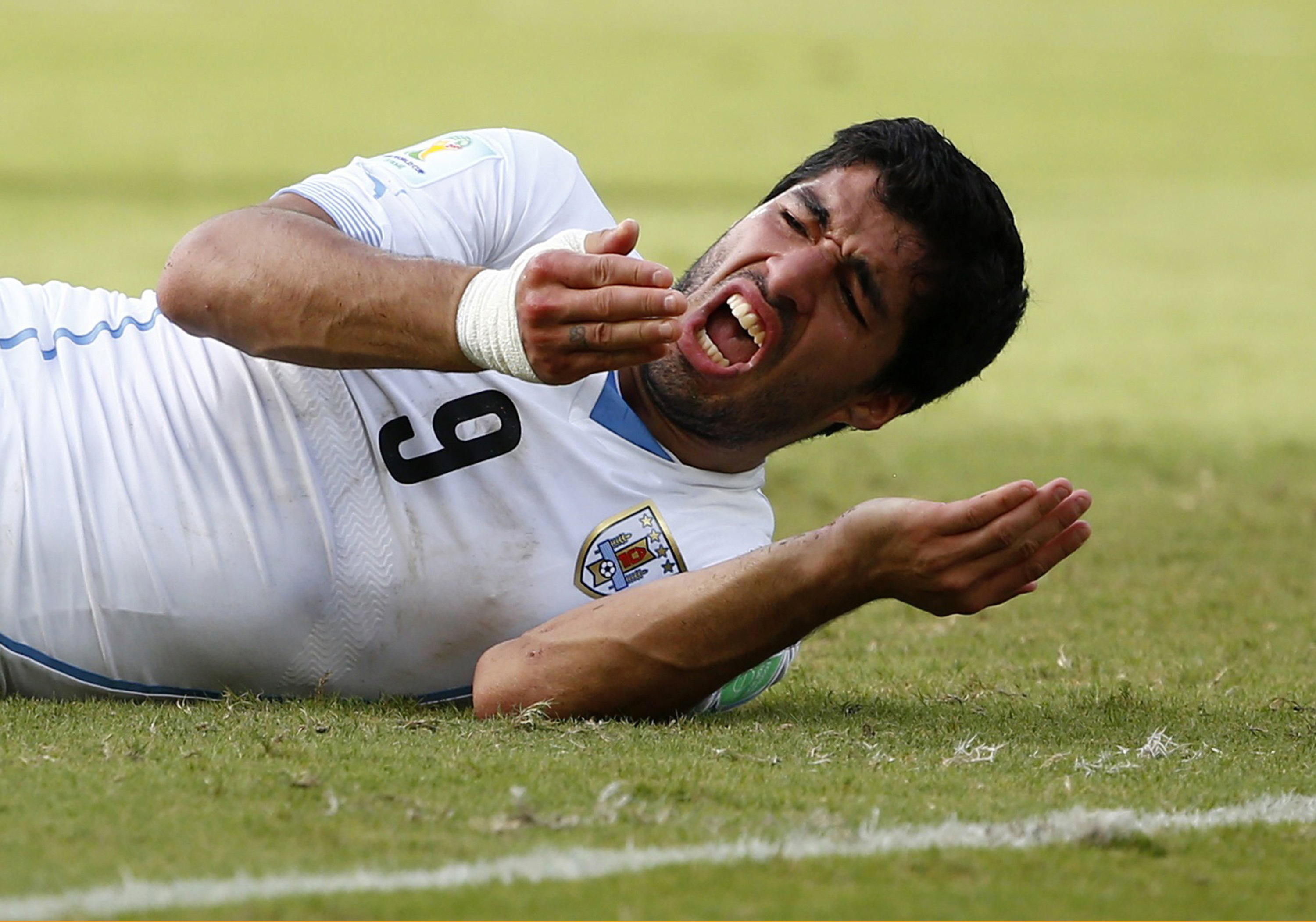 Uruguay's Luis Suarez reacts after clashing with Italy's Giorgio Chiellini during their 2014 World Cup Group D soccer match at the Dunas arena in Natal, Brazil on June 24, 2014.