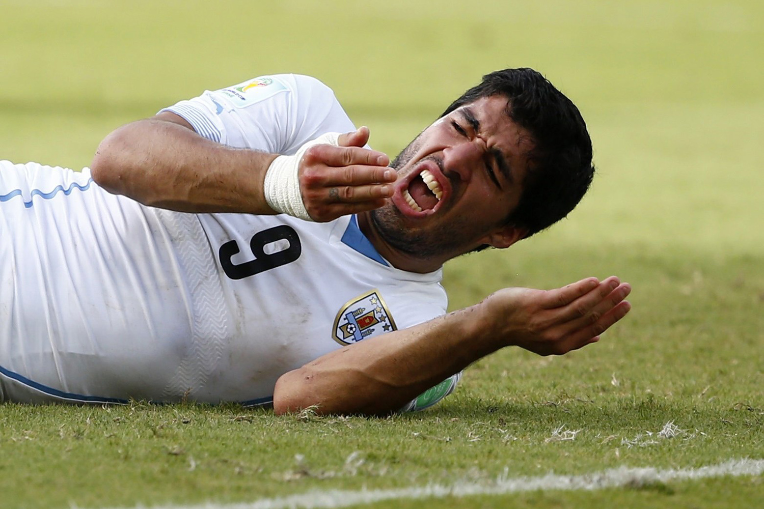 File photo of Uruguay's Luis Suarez reacting after clashing with Italy's Giorgio Chiellini during their 2014 World Cup Group D soccer match at the Dunas arena in Natal