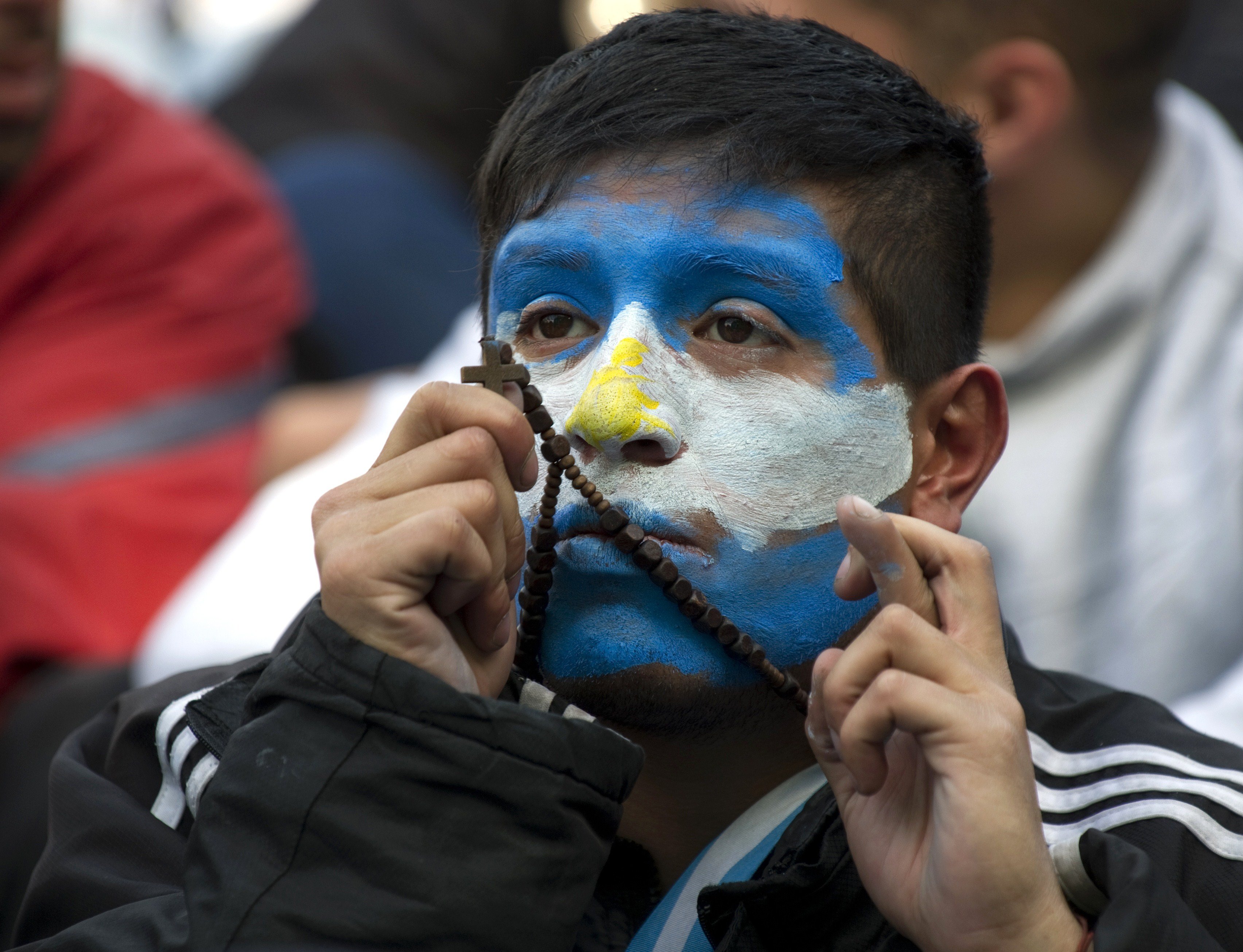 An Argentine fan reacts while watching the match against Nigeria on a big screen at San Martin Square, in Buenos Aires on June 25, 2014.