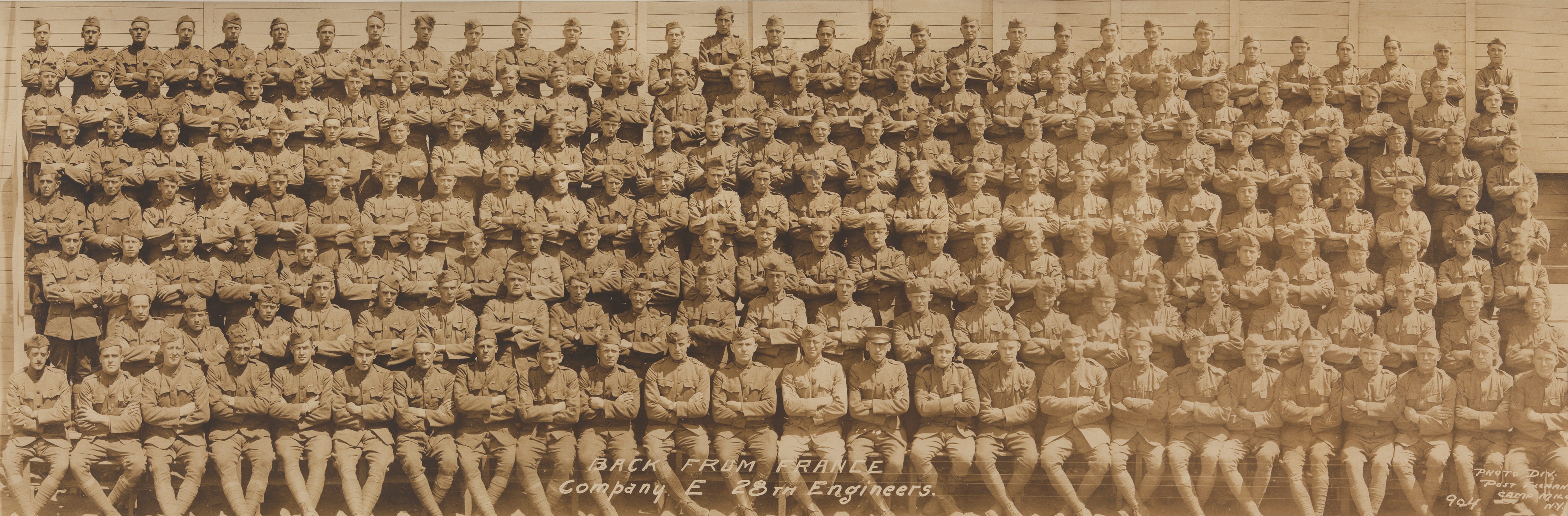 “Back from France, Company E, 28th Engineers, WWI
                              Photo Div. Post Exchange, Campy Mills, NY 904”