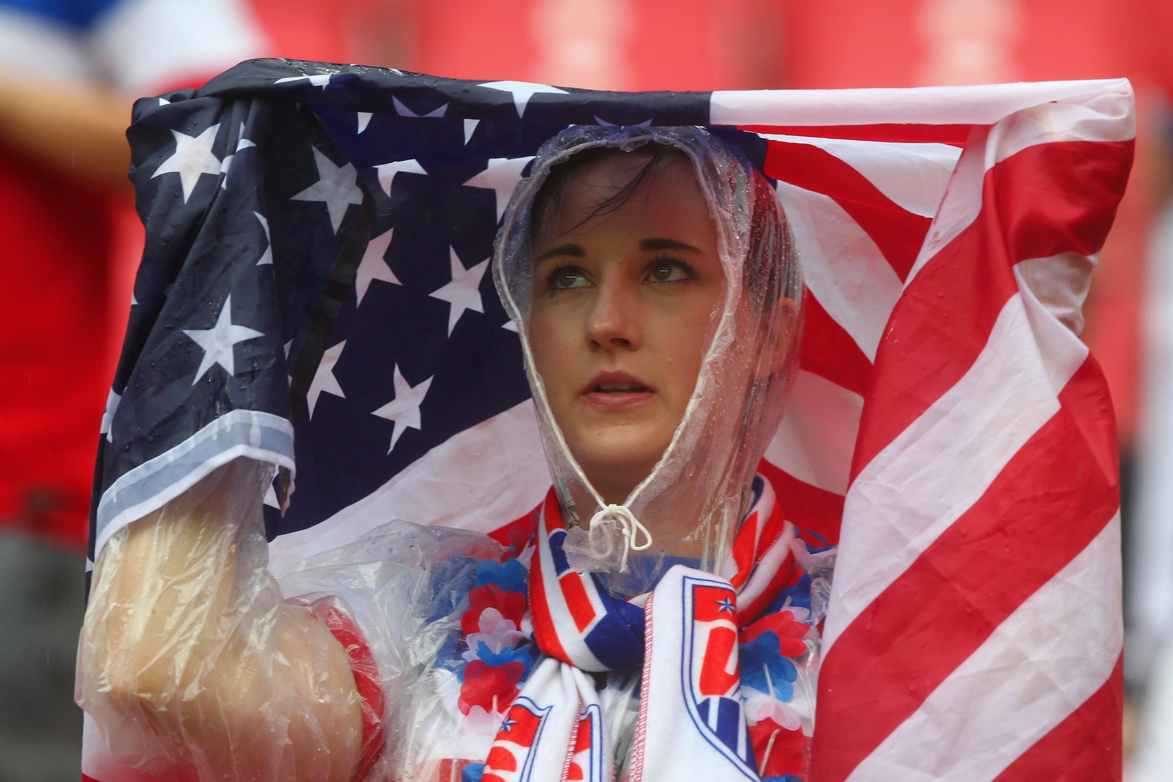 An United States fan looks on in the rain prior to the 2014 FIFA World Cup Brazil group G match between the United States and Germany at Arena Pernambuco on June 26, 2014 in Recife, Brazil.
