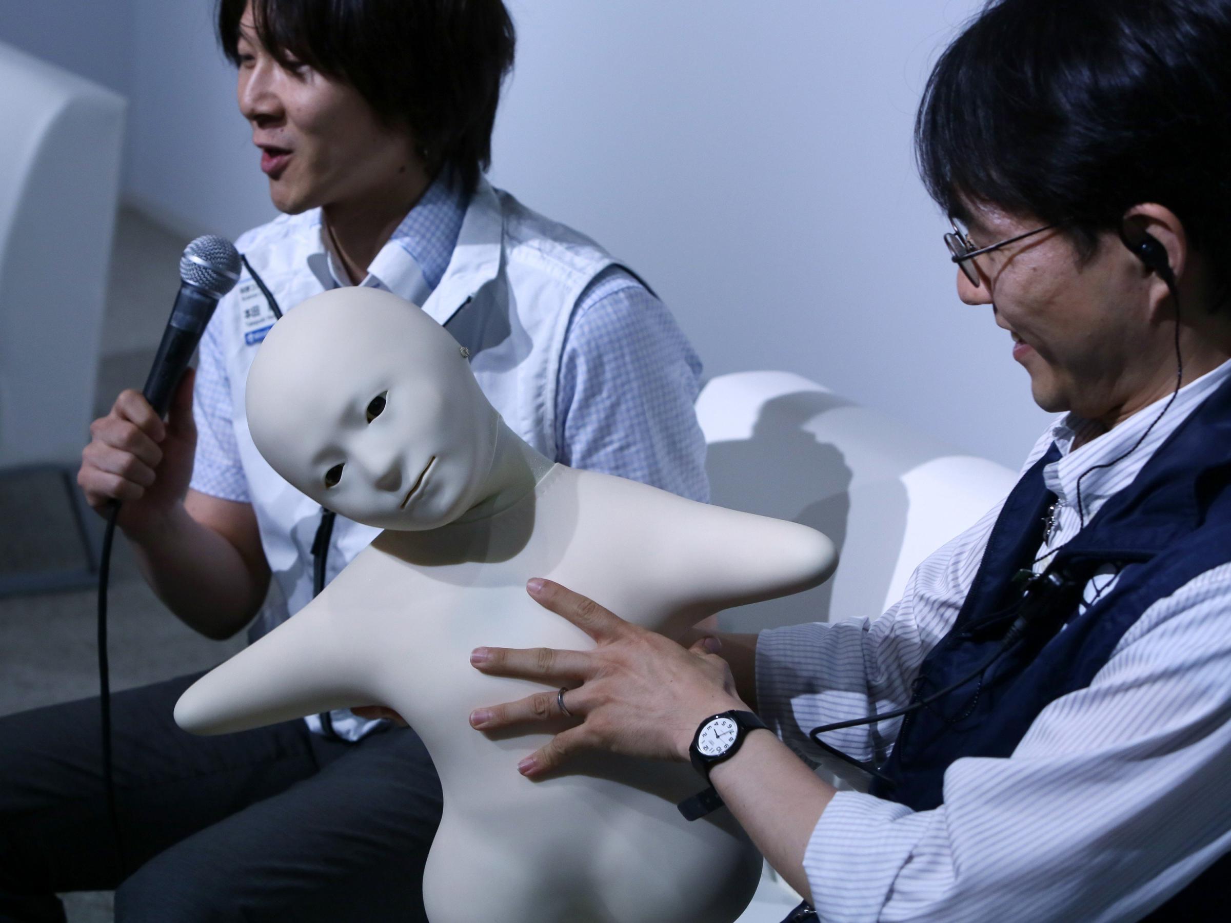 Telenoid is a teleoperated android robot with a minimal design, created as an attempt to embody the minimum physical requirements for humanlike communication during a press preview at the National Museum of Emerging Science and Innovation Miraikan in Tokyo on June 24, 2014.