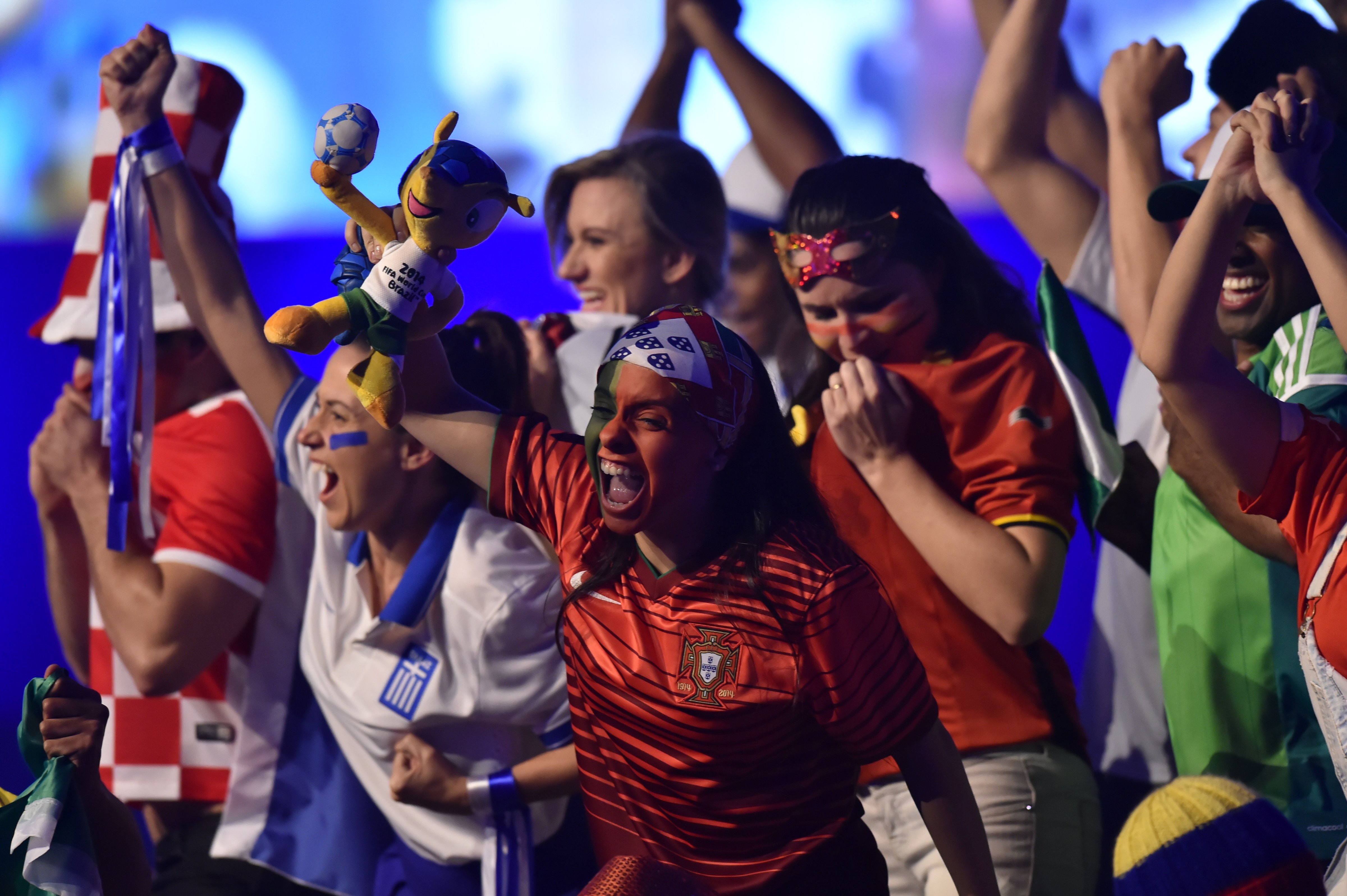 Performers dressed as football fans dance on stage during the opening of the FIFA Congress in Sao Paulo on June 10, 2014, two days before the opening match of the 2014 FIFA World Cup in Brazil. (Nelson Almieda—AFP/Getty Images)