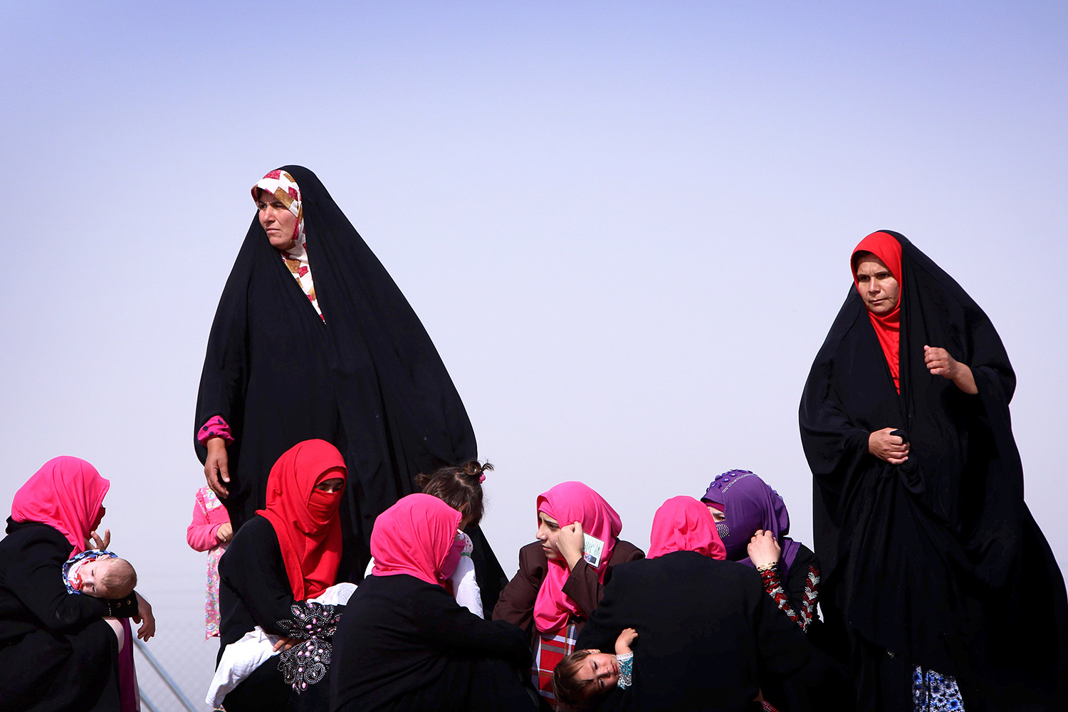Iraqi women gather at a temporary camp set up to shelter civilians fleeing violence in northern Nineveh province in Aski Kalak, 25 miles west of Erbil, on June 13.