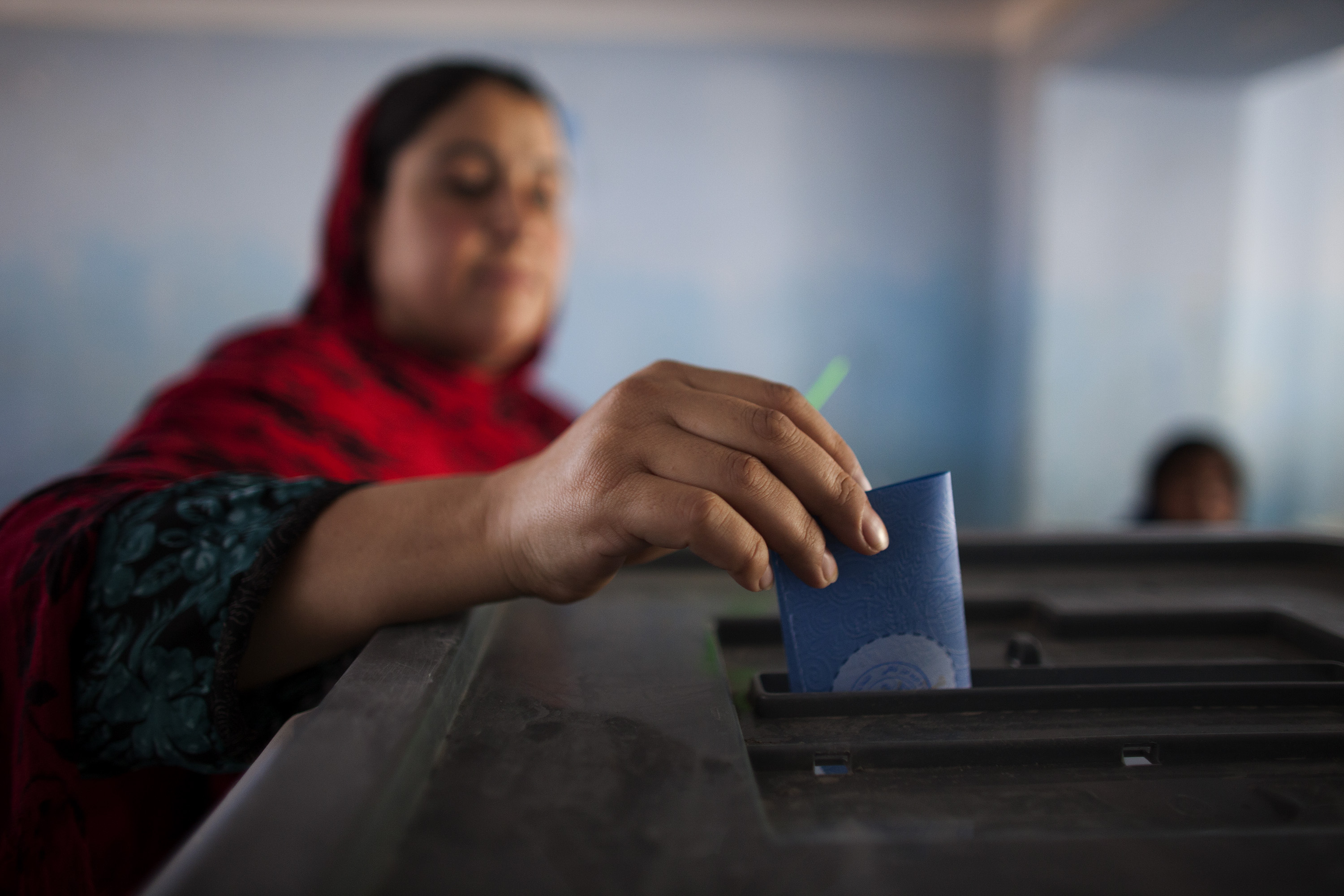 An Afghan woman casts her ballot during the second round for presidential election at a polling station in Kabul, Afghanistan, on June 14, 2014. (Majid Saeedi&mdash;Getty Images)